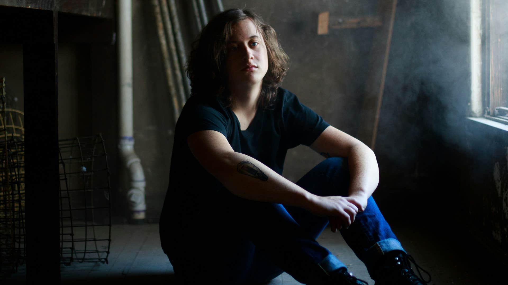 young man sitting looking disappointed on the floor