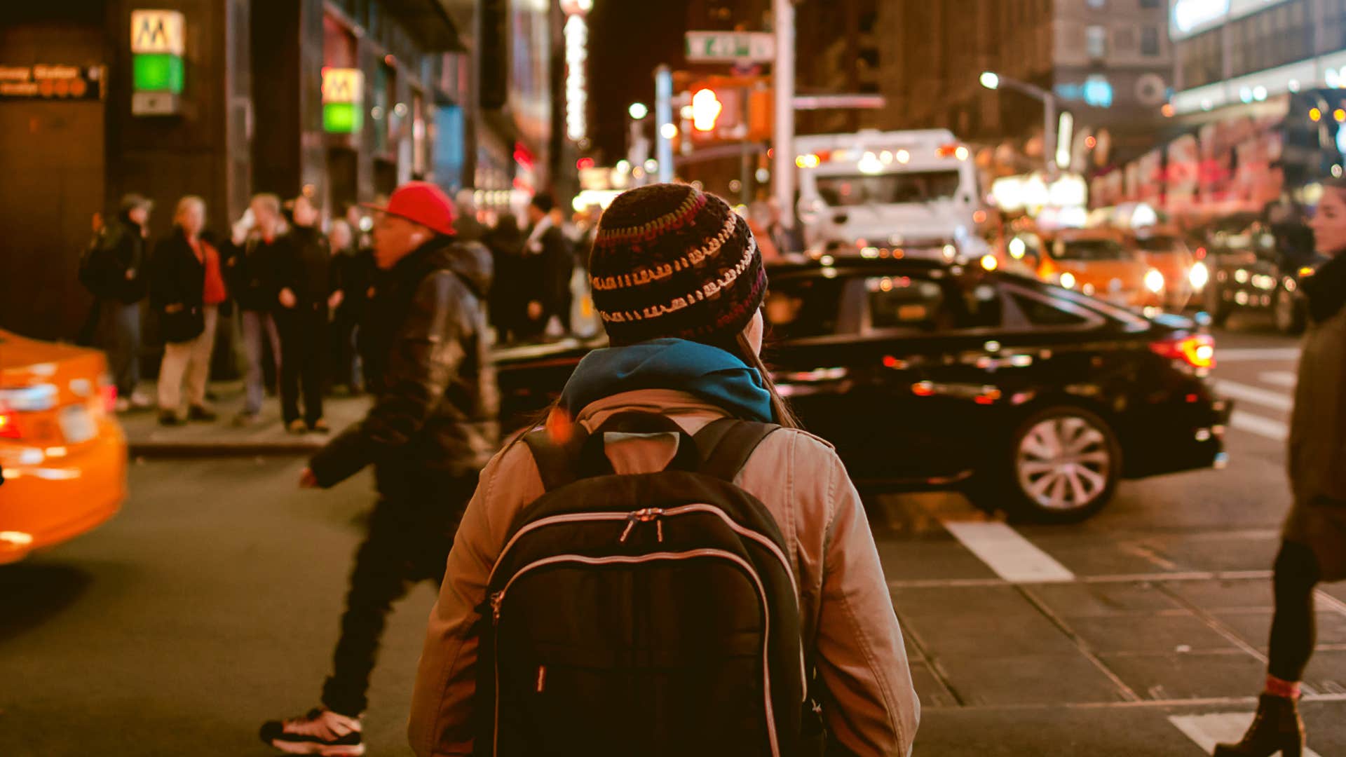 woman crossing busy city street alone