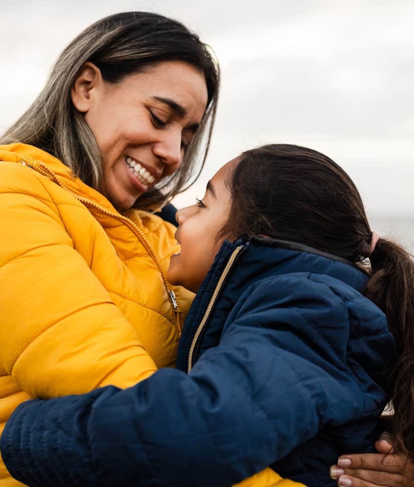 Happy mother with daughter talking and elevating self-esteem