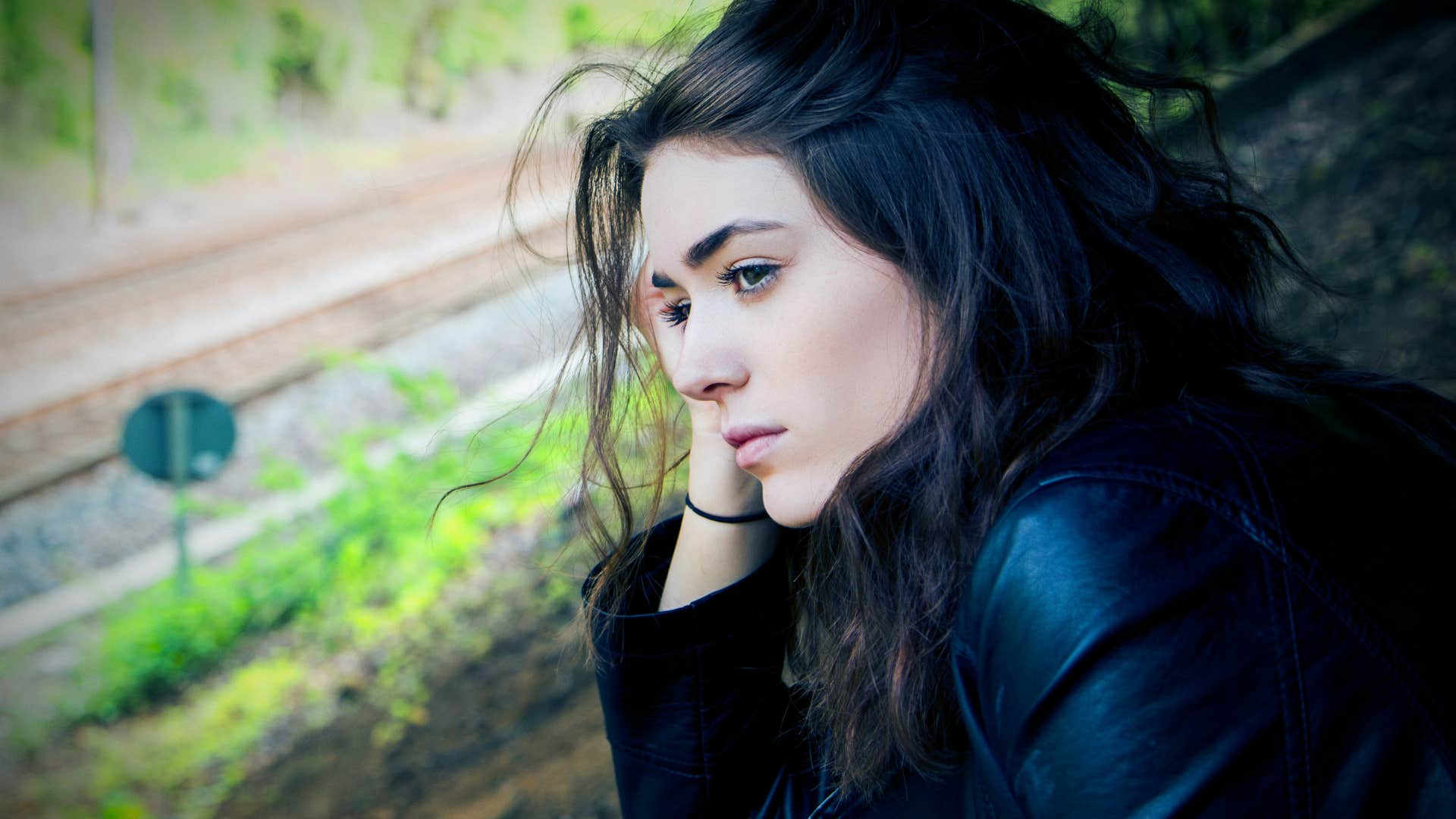 sad woman with brown hair looking into the distance