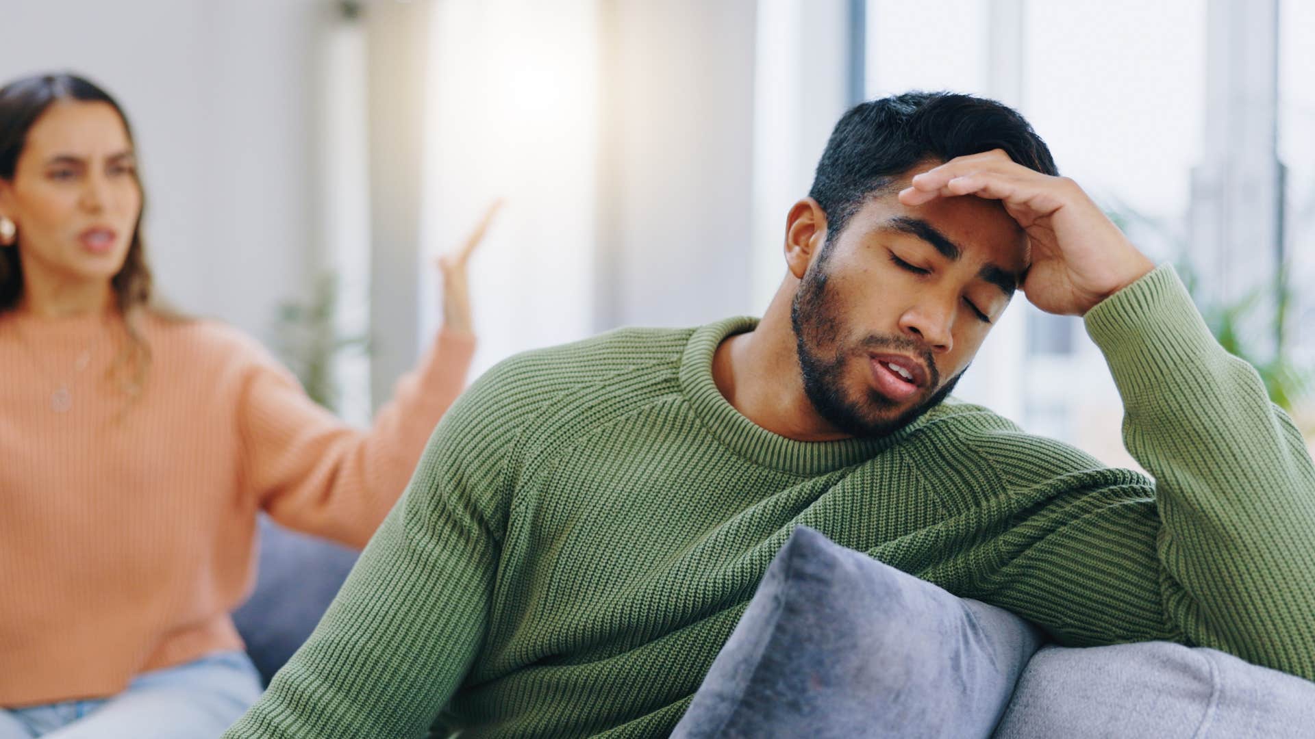 man suppressing his true emotions during argument