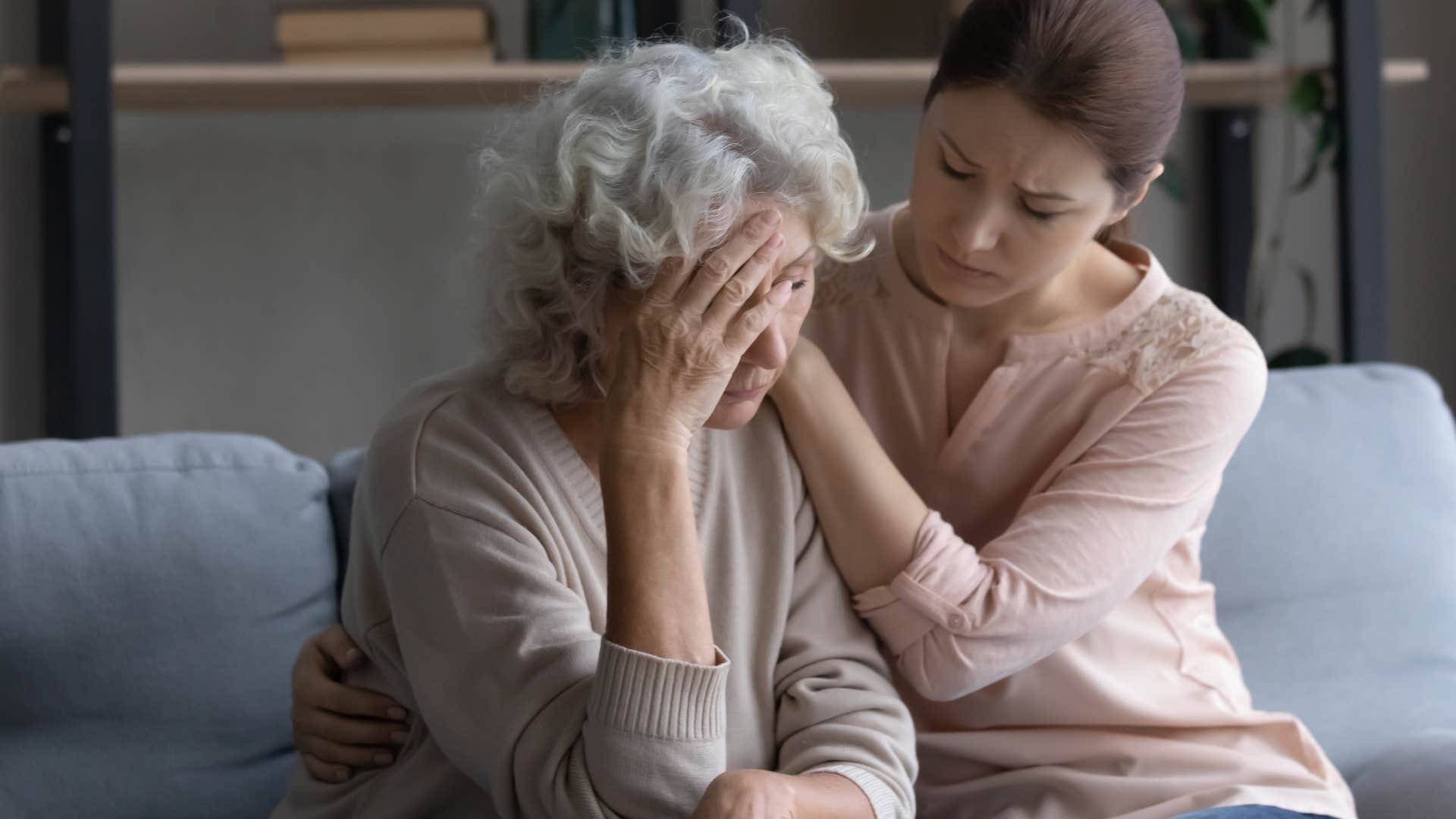 Woman comforting her upset boomer mother