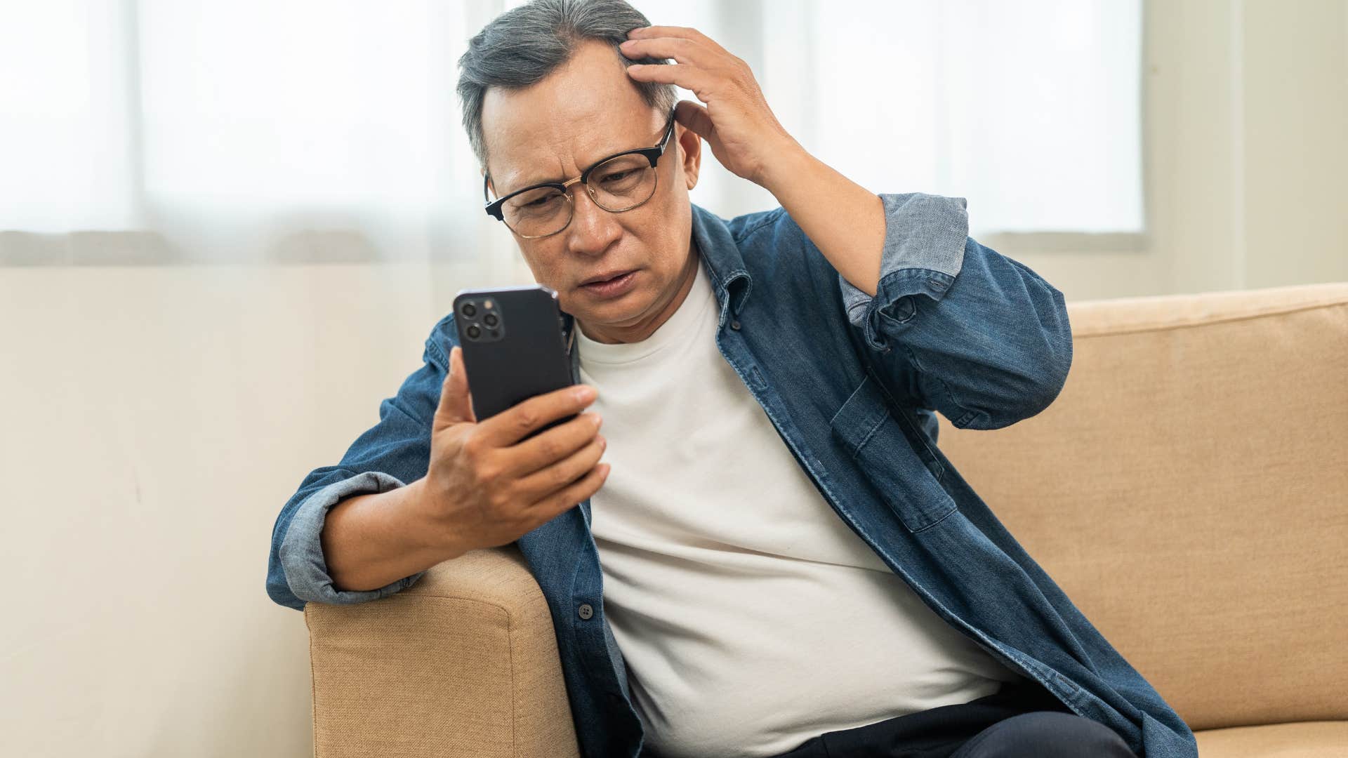 Stressed boomer man over-working himself