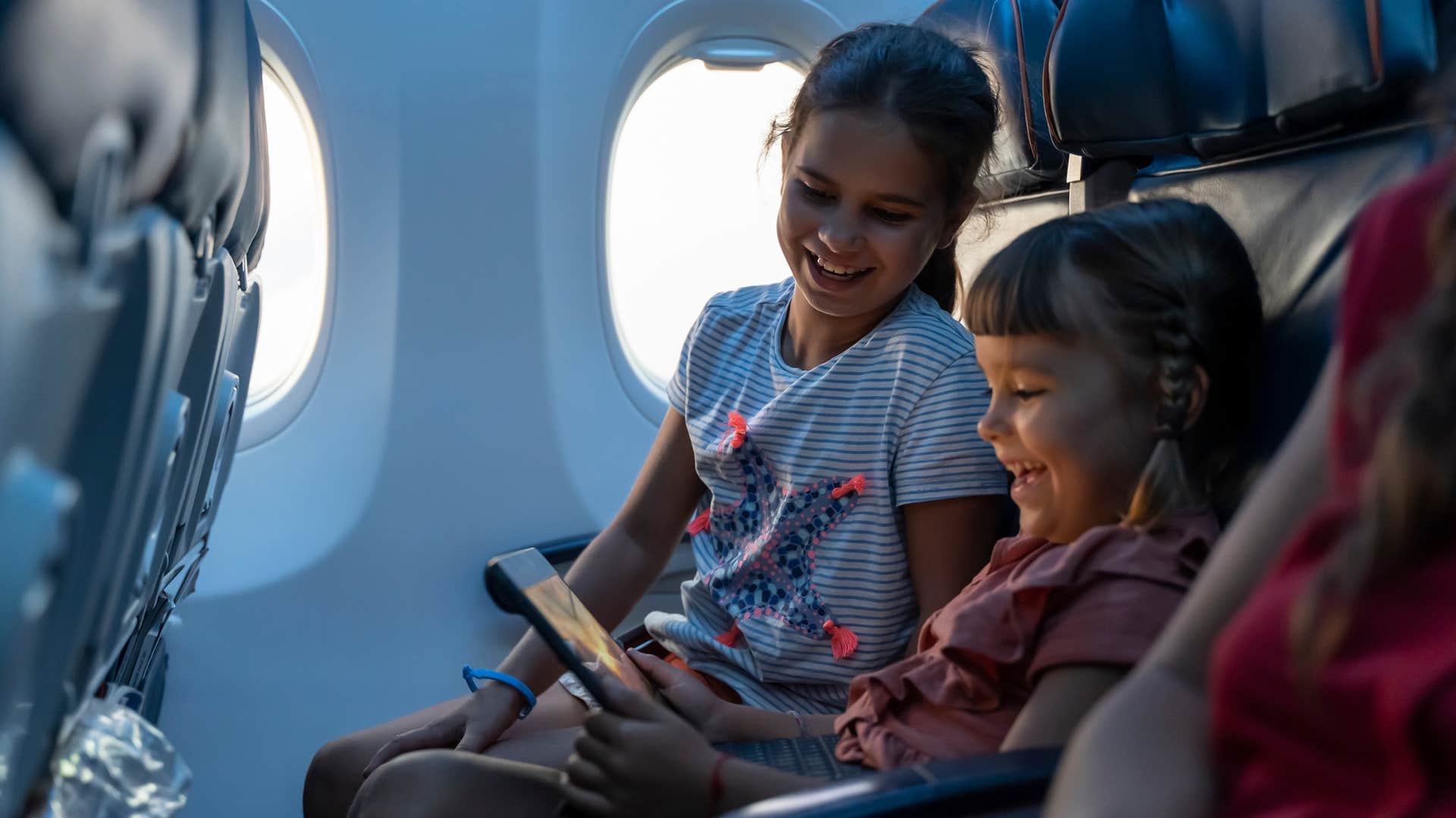 young girls traveling on a plane