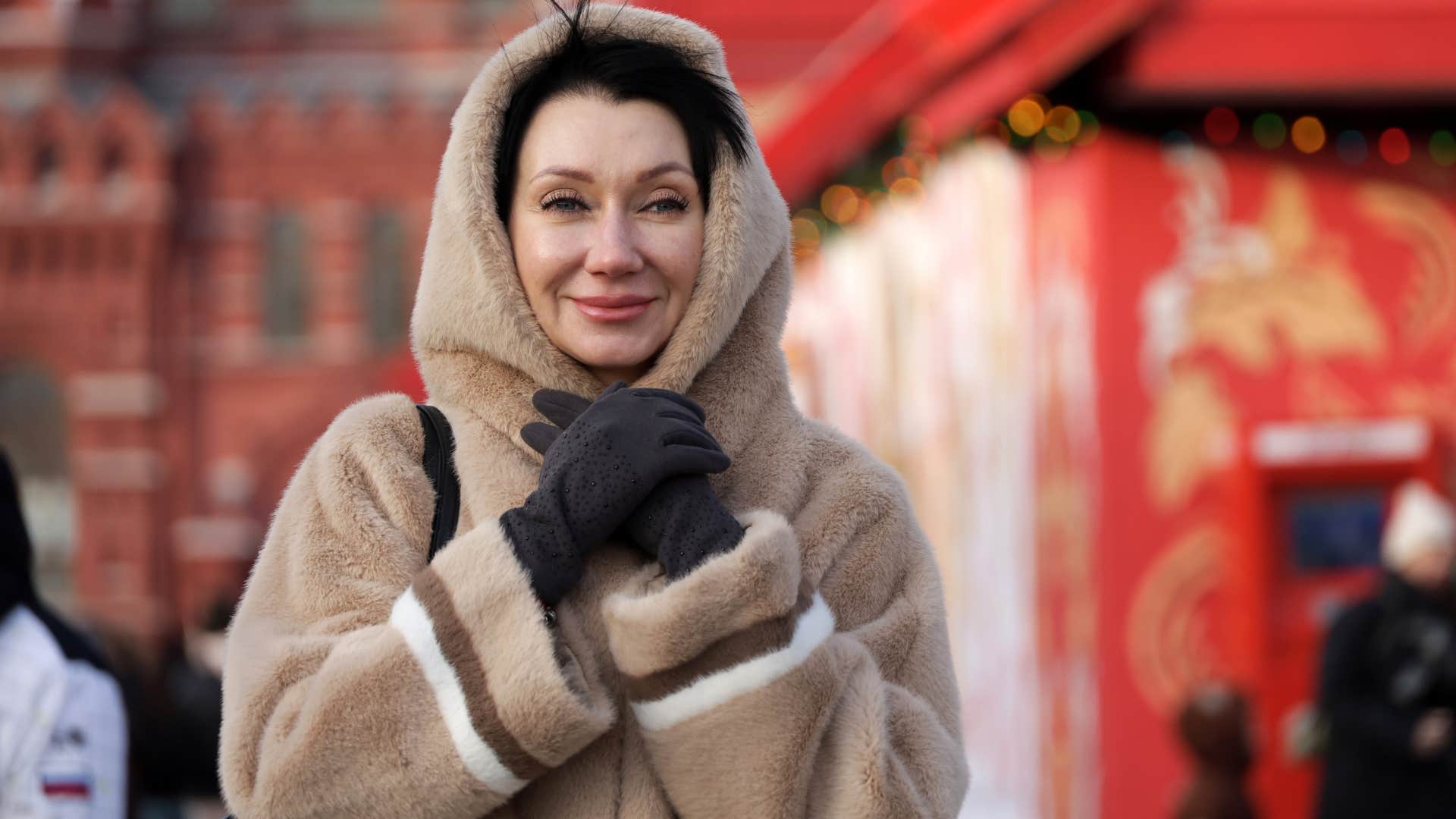 woman smiling in a fur coat