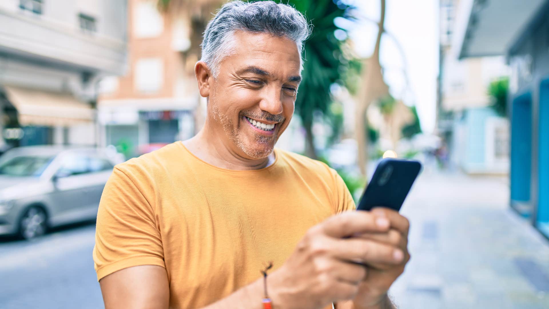 man smiling on his phone