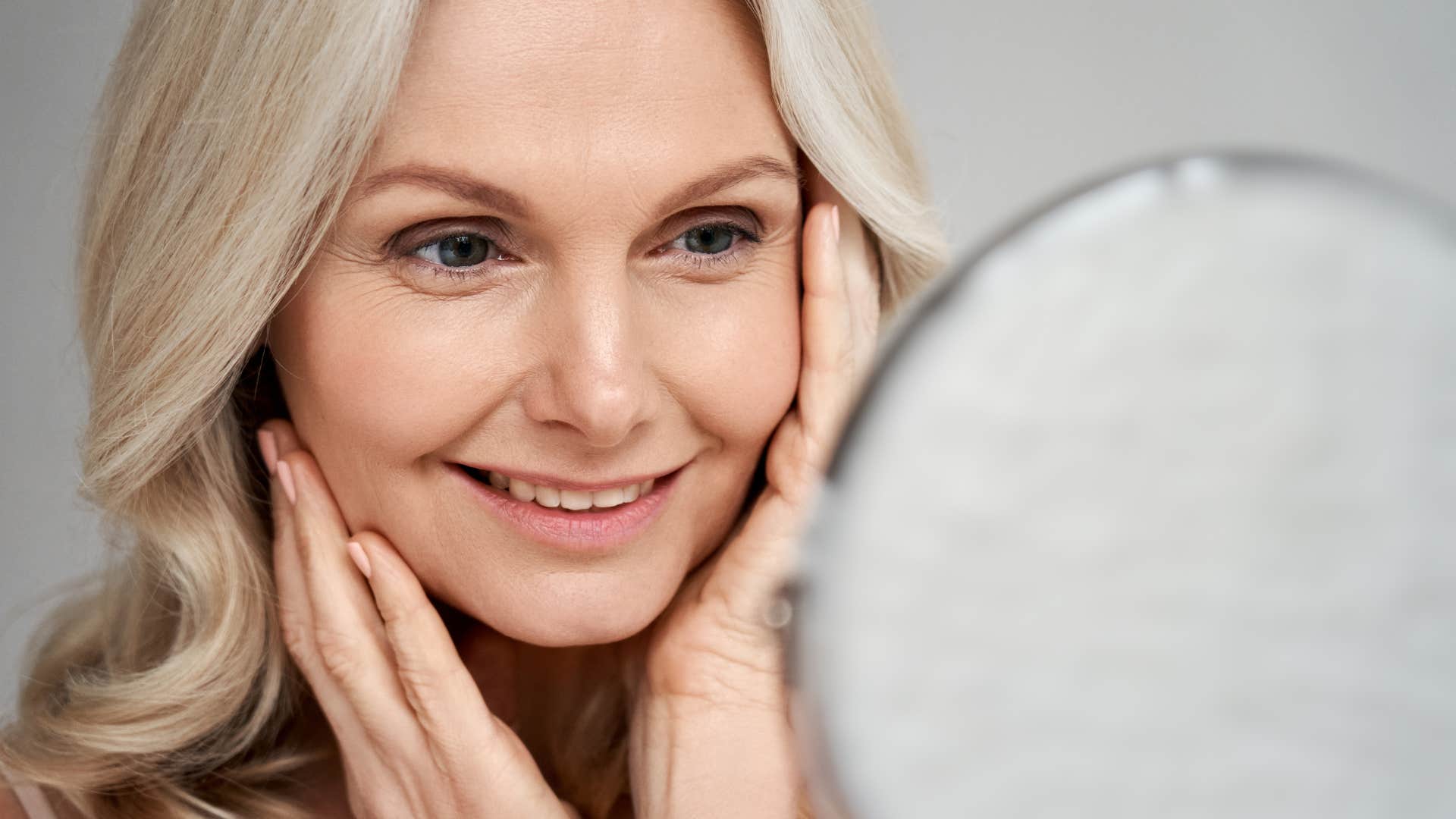 older woman looking in a mirror