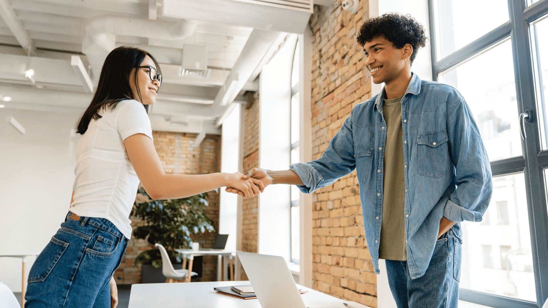 woman shaking hands with man who gave feedback