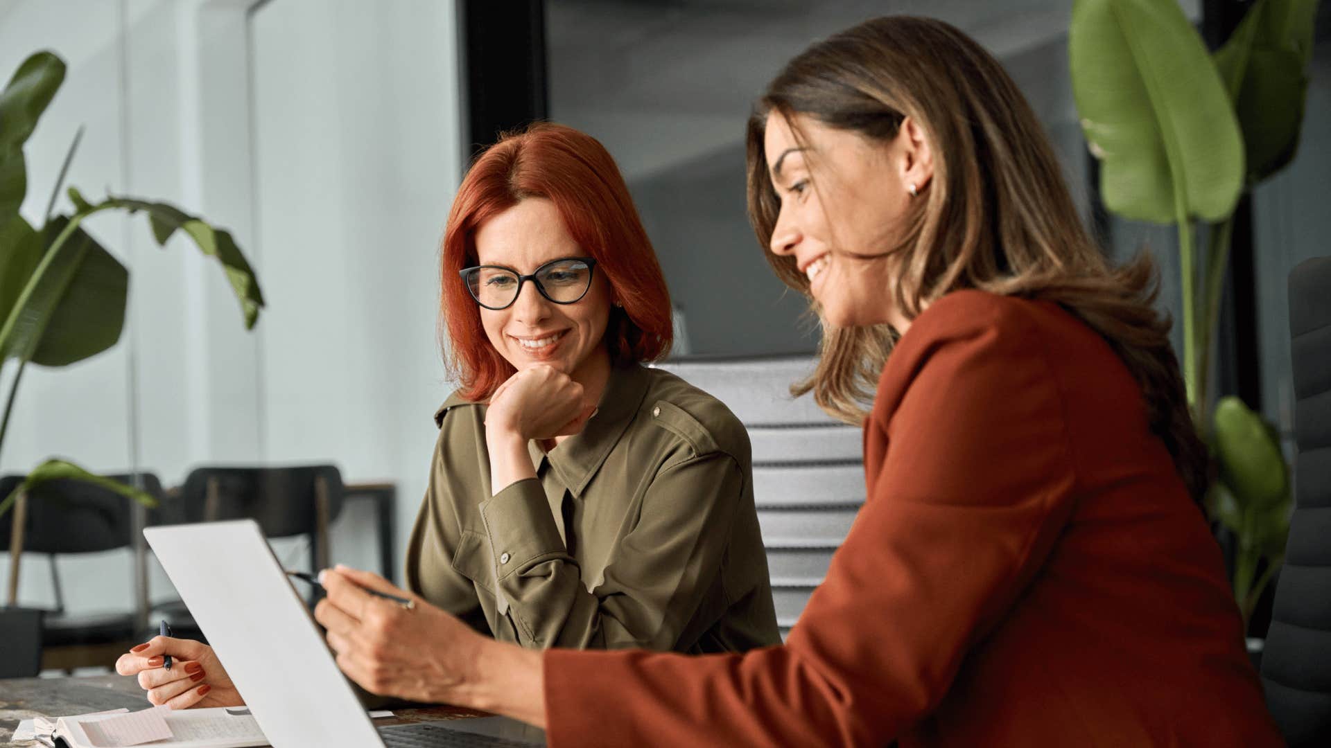 workers looking at laptop together facing challenges