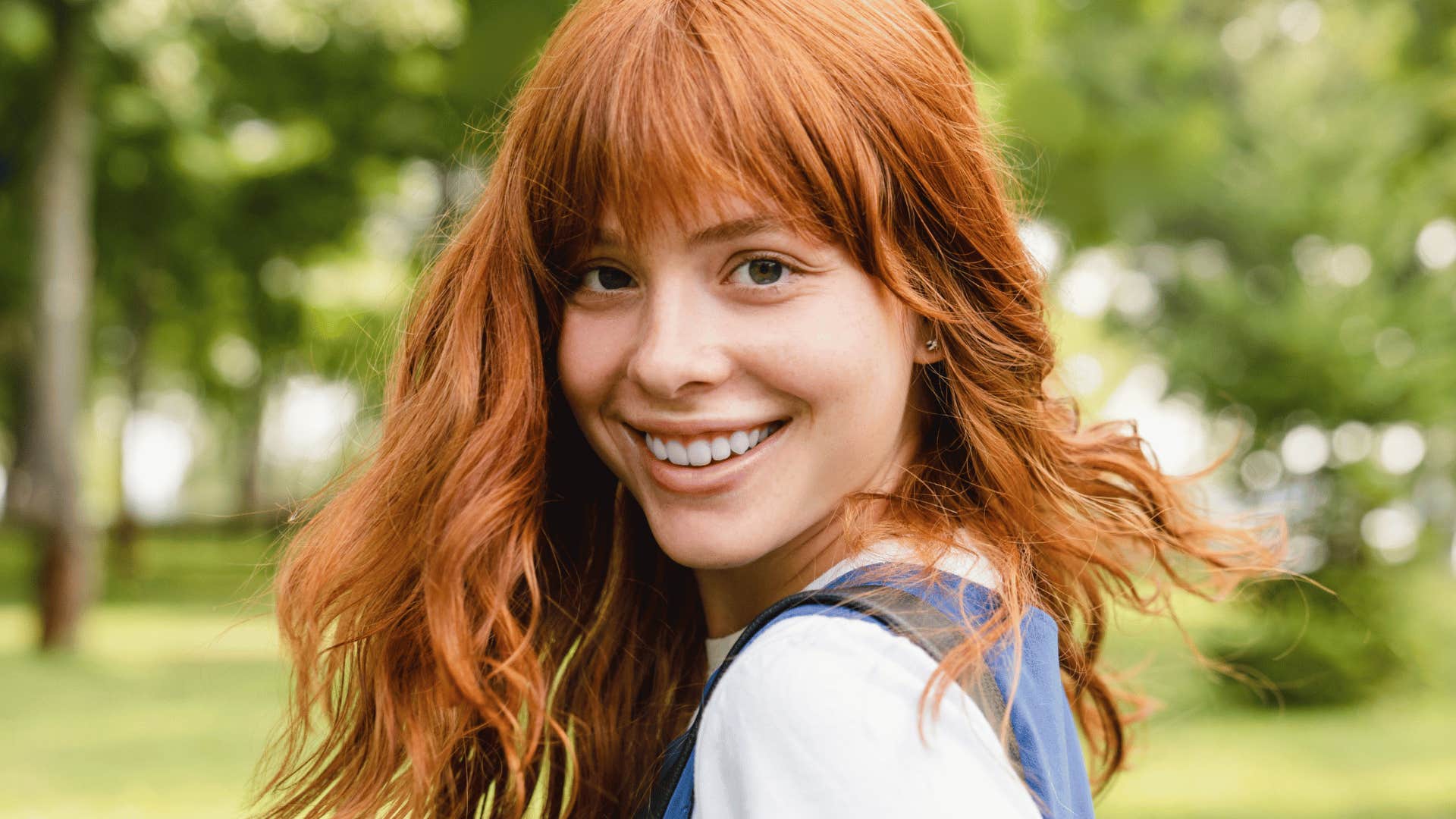 redheaded woman smiling bright