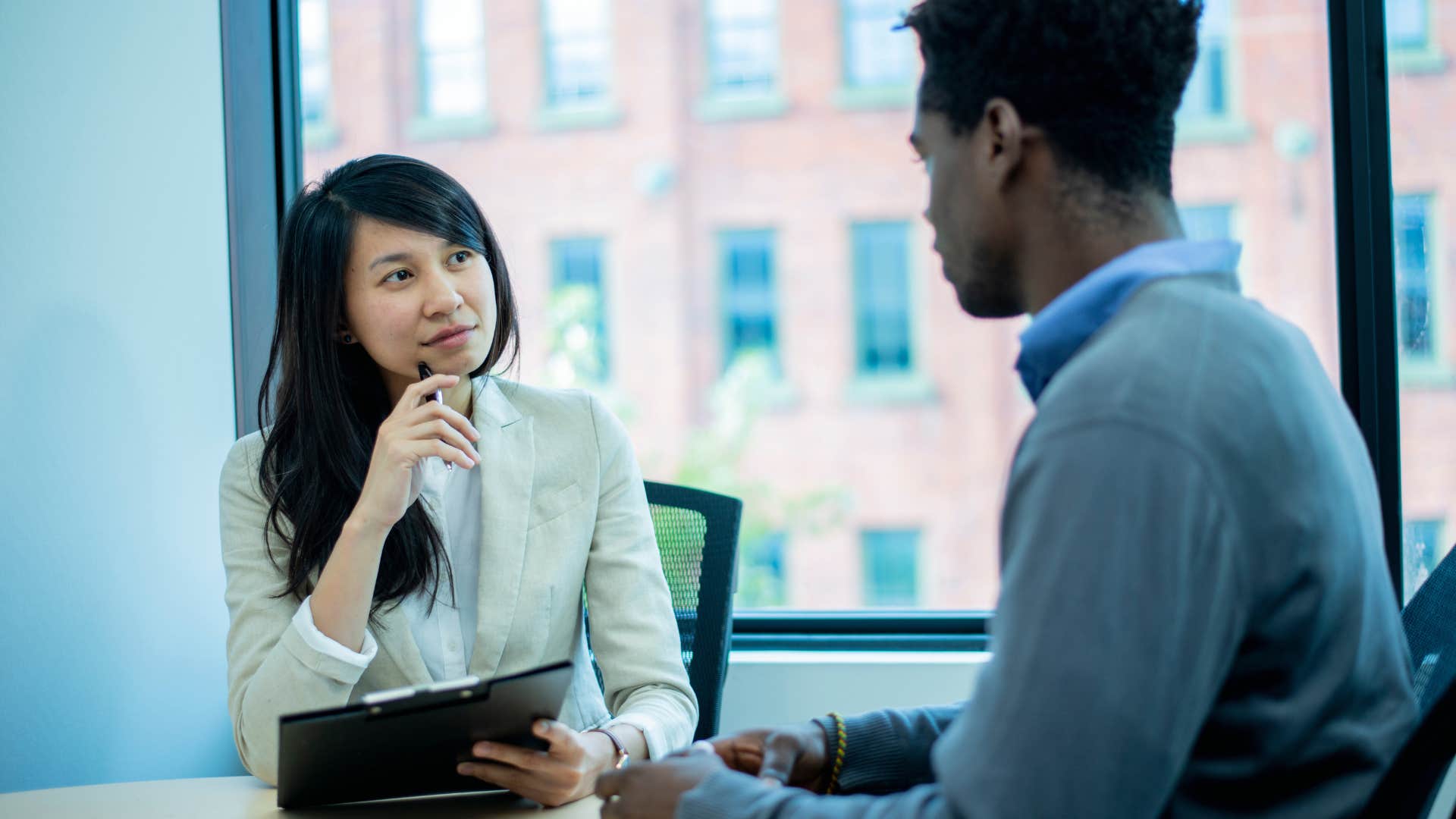 woman listening carefully while coworker speaks