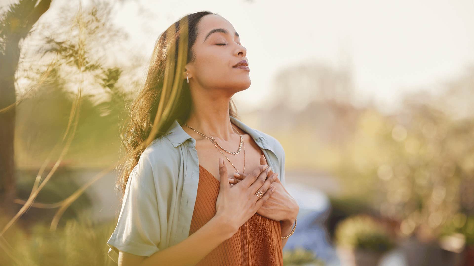 woman deep breathing outside 