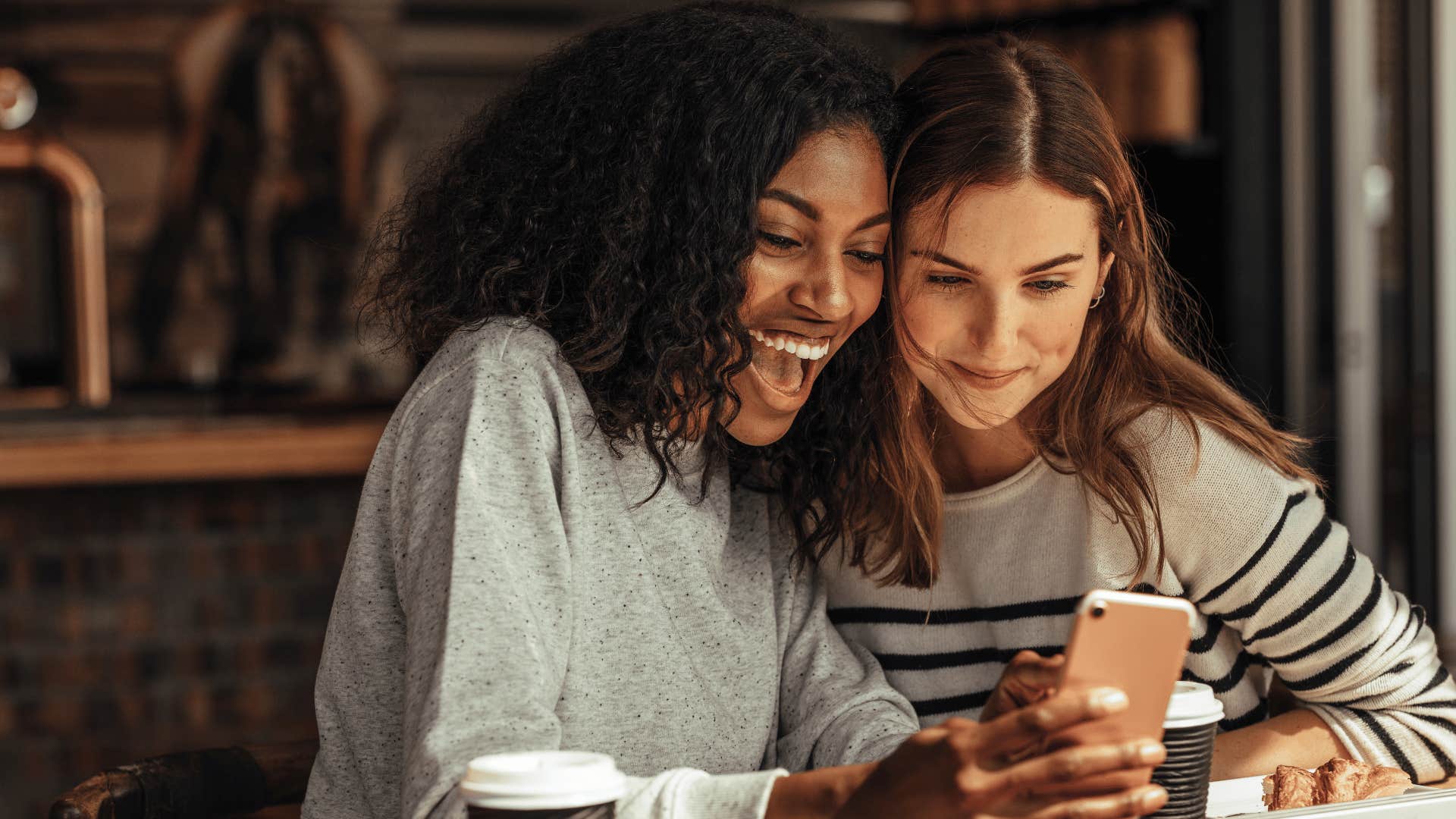 woman looking at phone together