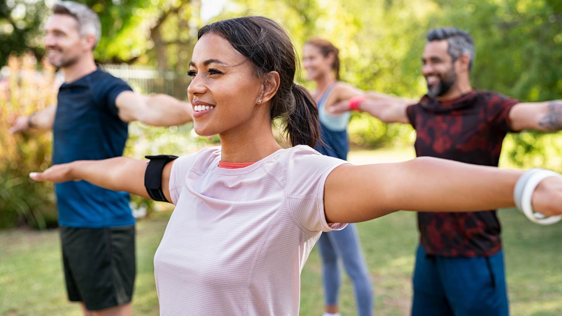 Gen Z woman in an outdoor workout class