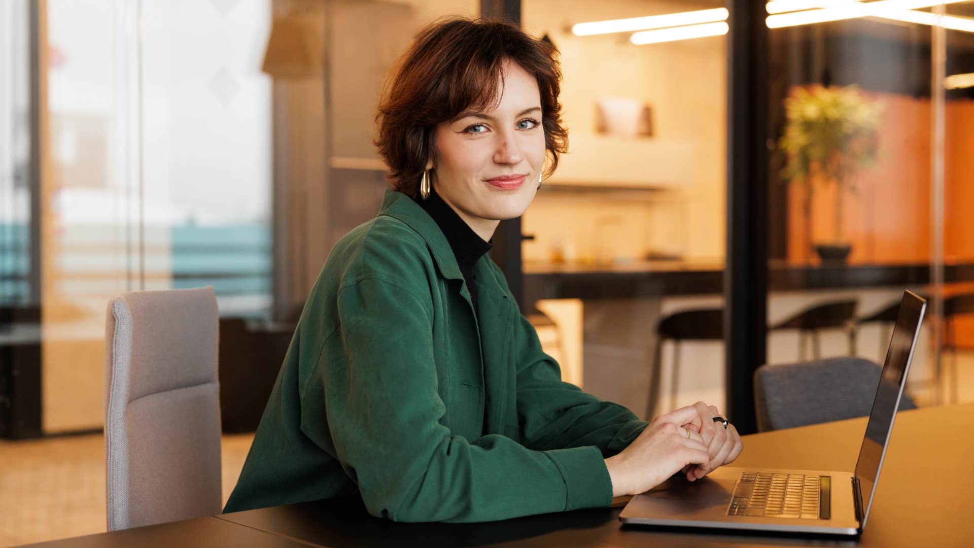 Gen Z woman working in office on laptop