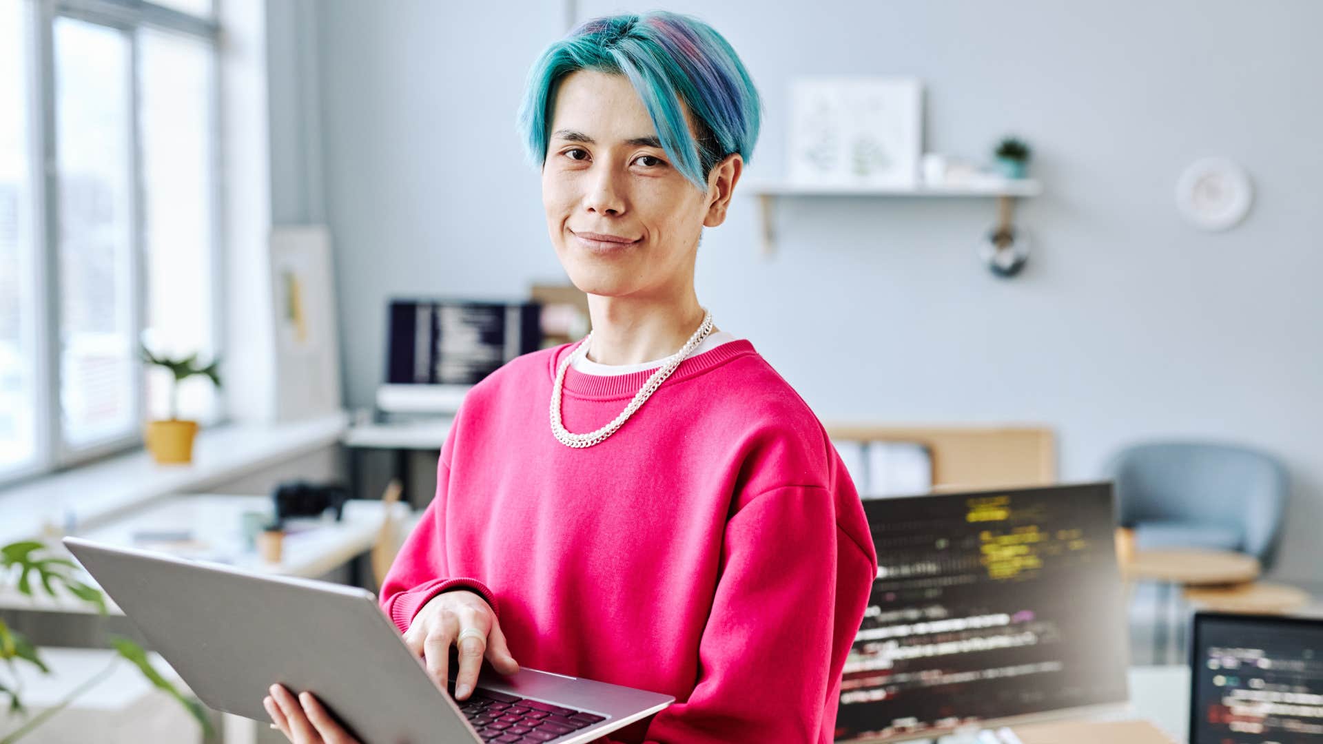 Gen Z woman working in office on laptop