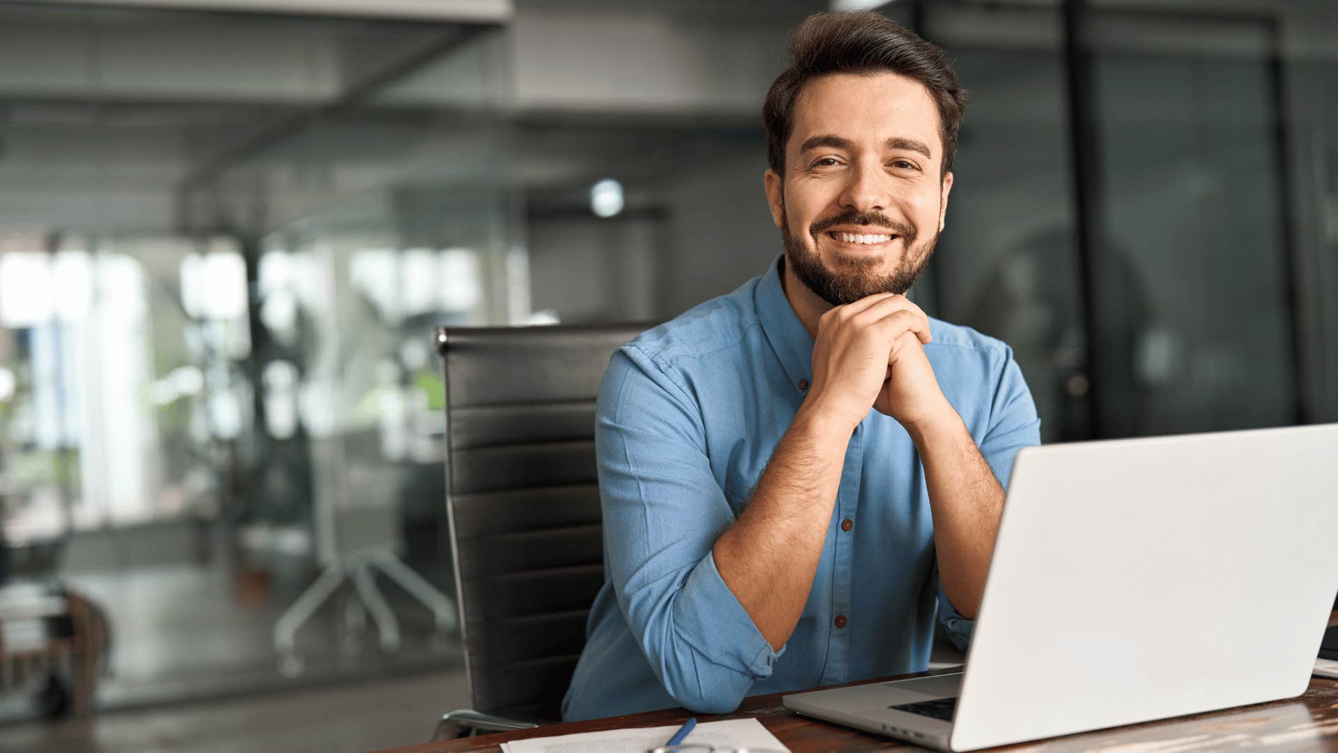 good man smiling while having head in hands