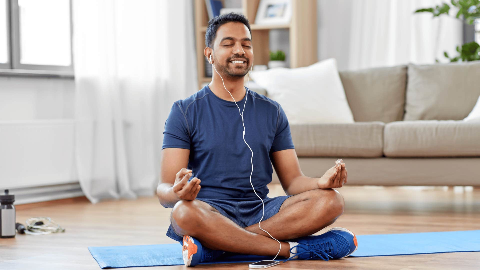 good man meditating indoors