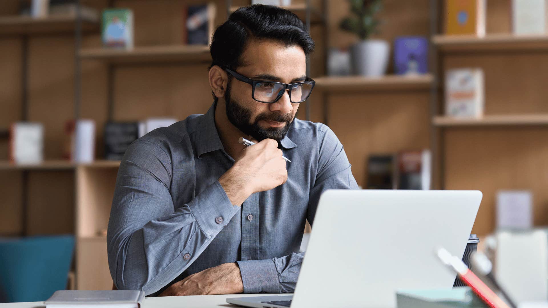 good man working on laptop and thinking 