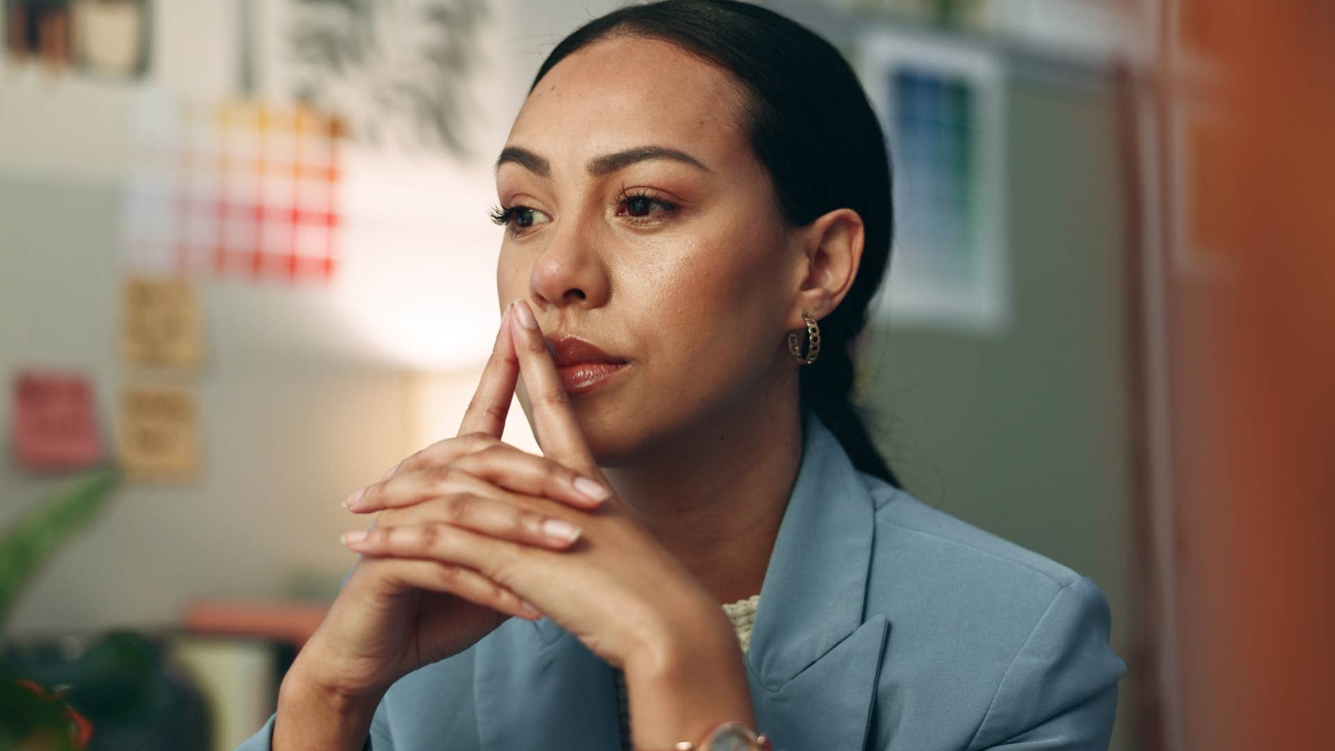 upset woman thinking at her desk