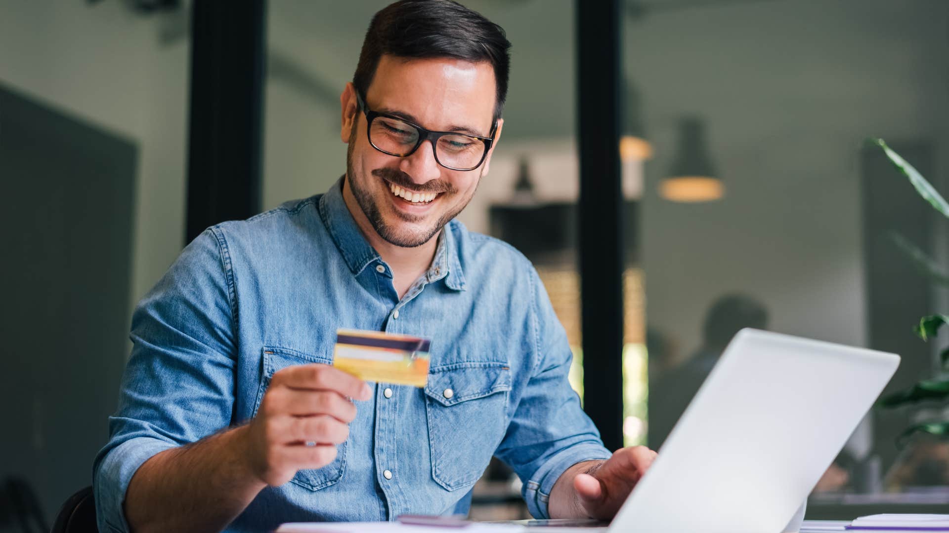 man holding credit card to pay a bill