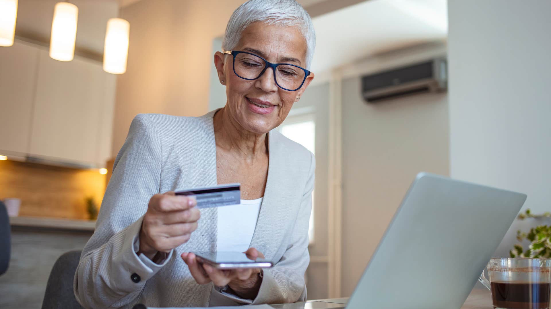 woman smiling and holding her credit cards