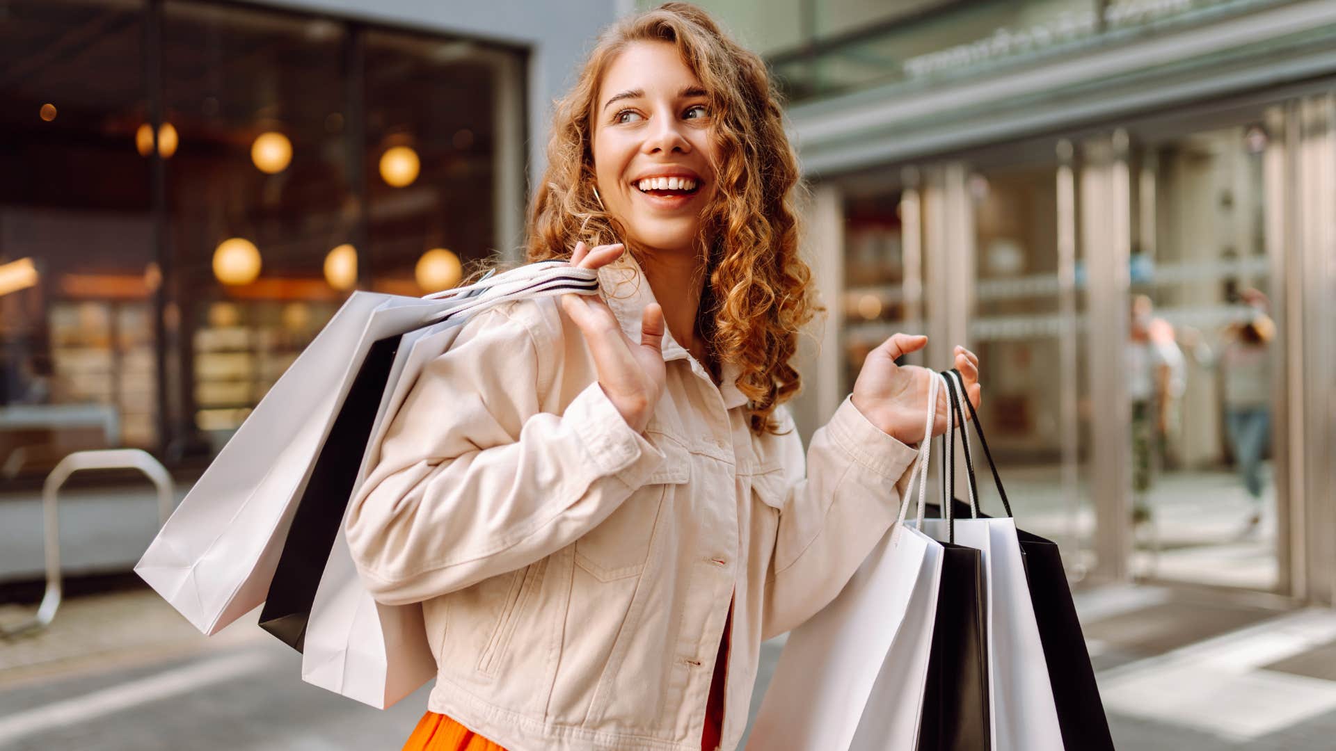 woman holding numerous shopping bags