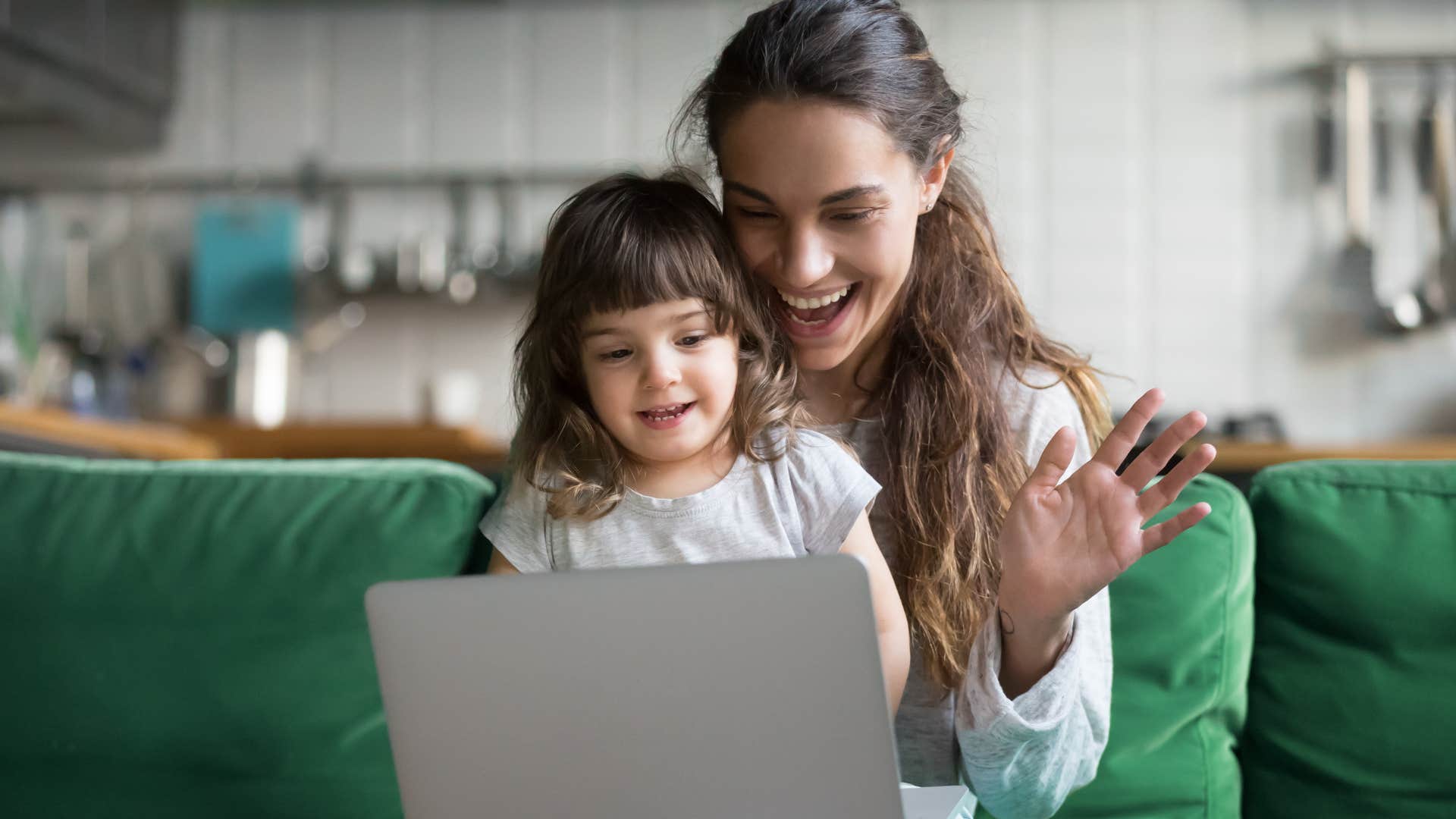 woman and young daughter using a laptop