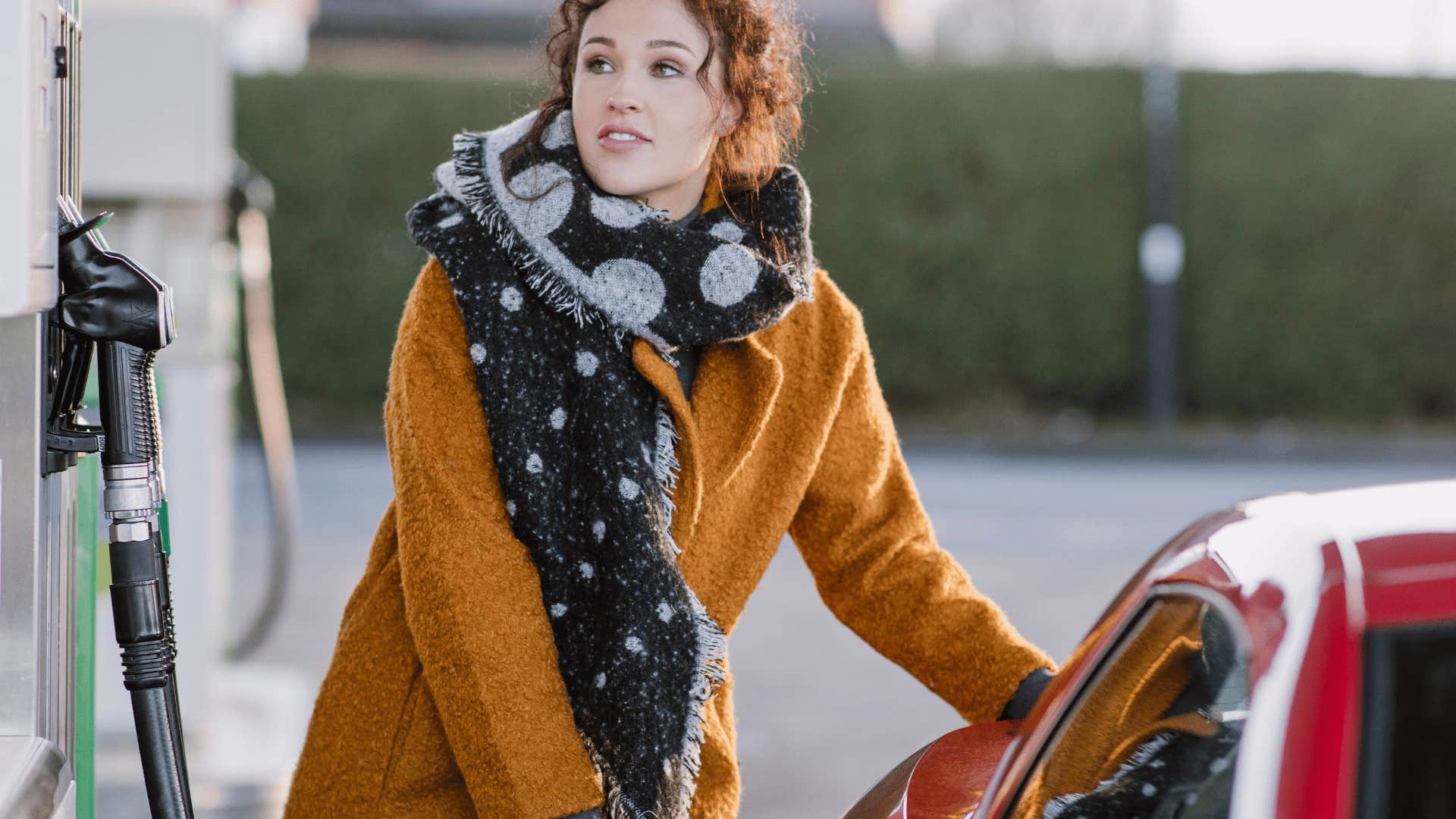 middle class woman getting gas