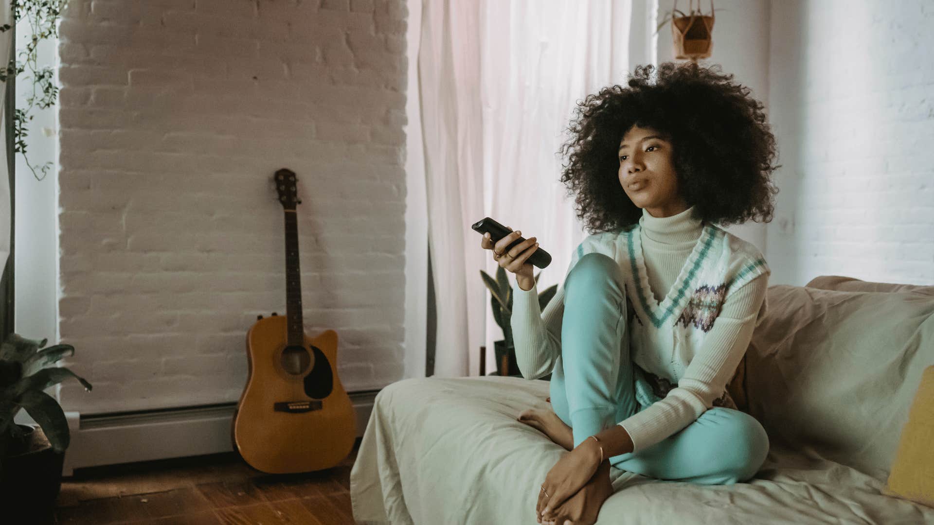 middle class young woman watching tv