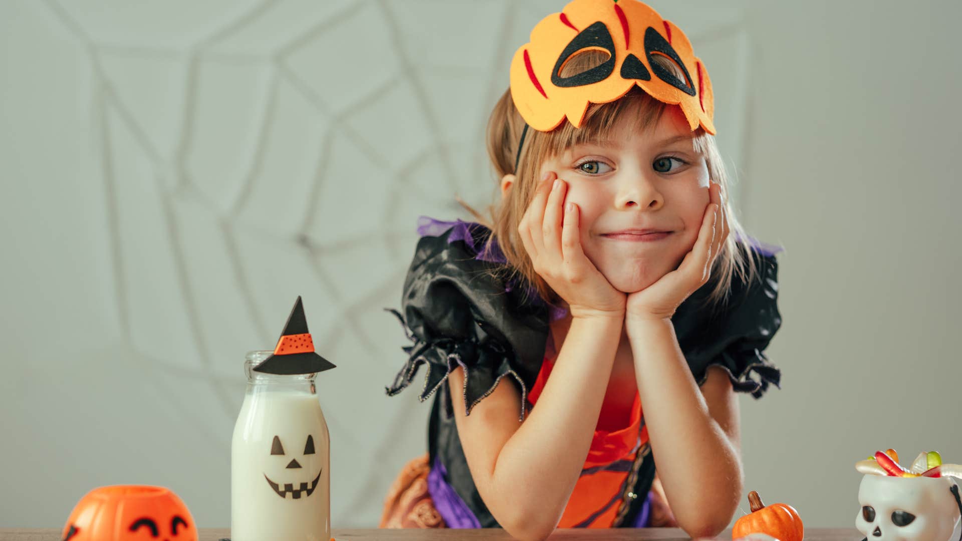 little girl in a Halloween costume smiling 