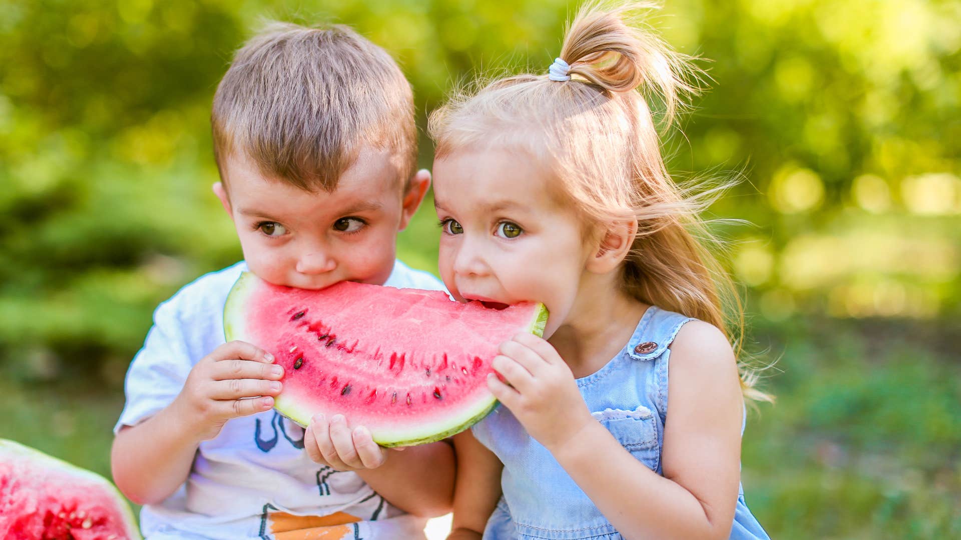 little kids eating watermelon