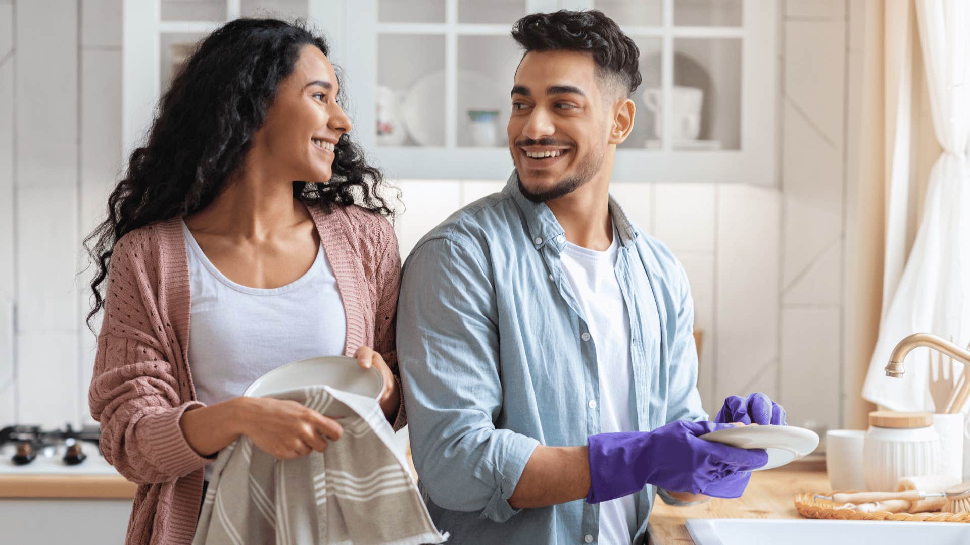 a truly loving husband cleaning the dishes while the wife dries them