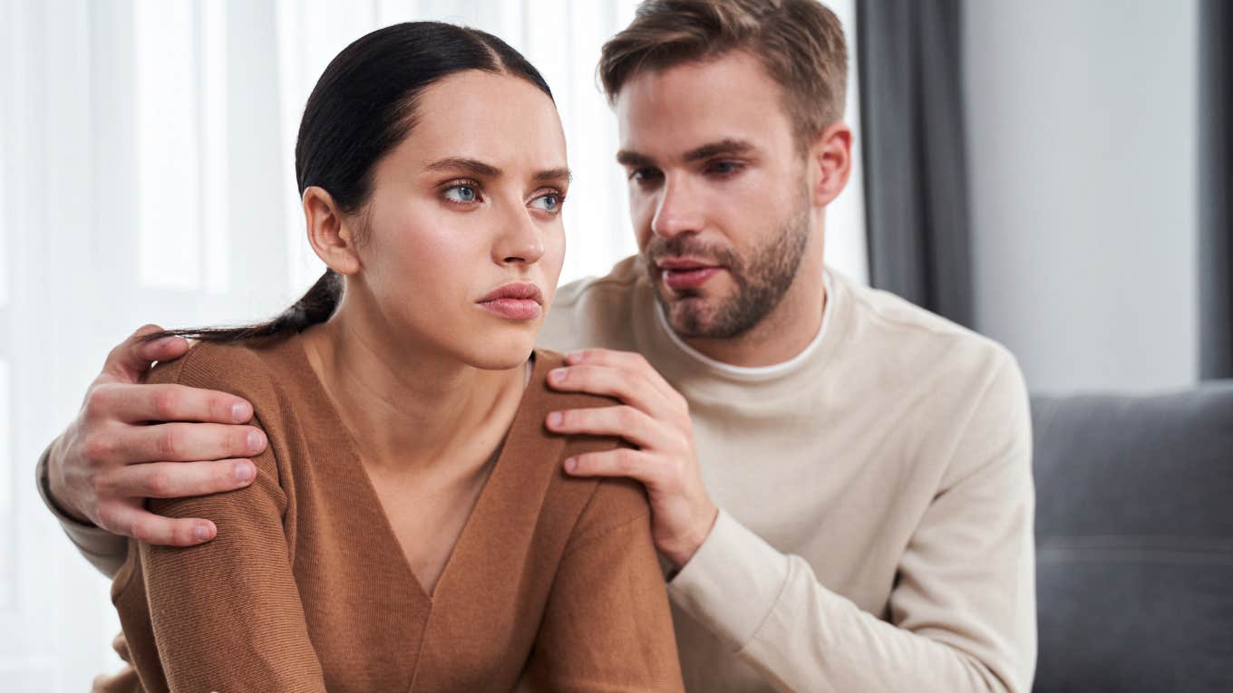 unhappy wife sitting next to husband