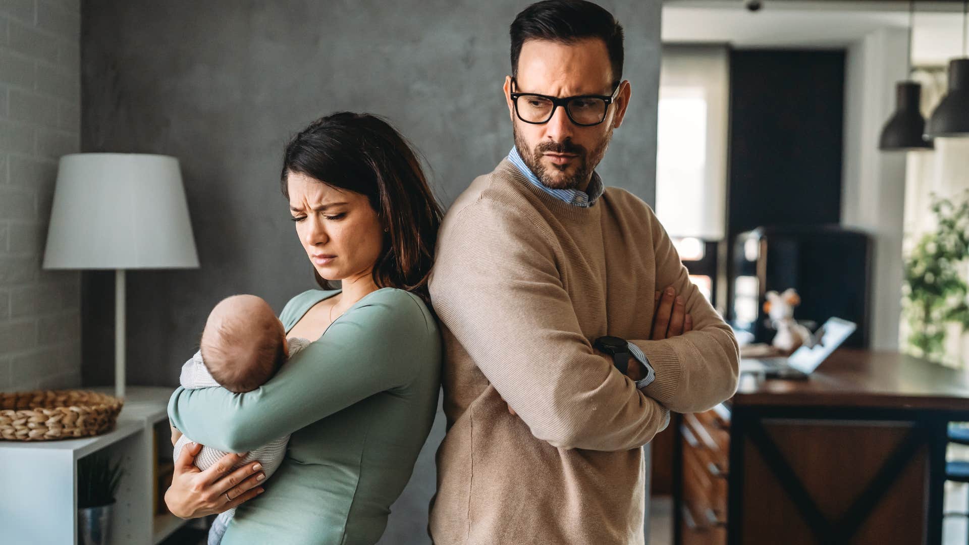 upset couple with newborn baby