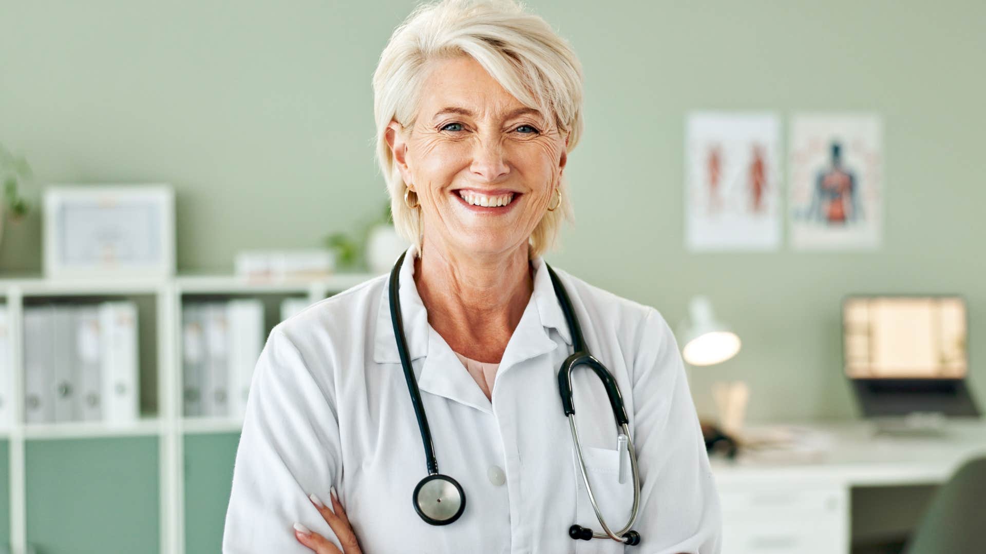 female doctor smiling and crossing her arms