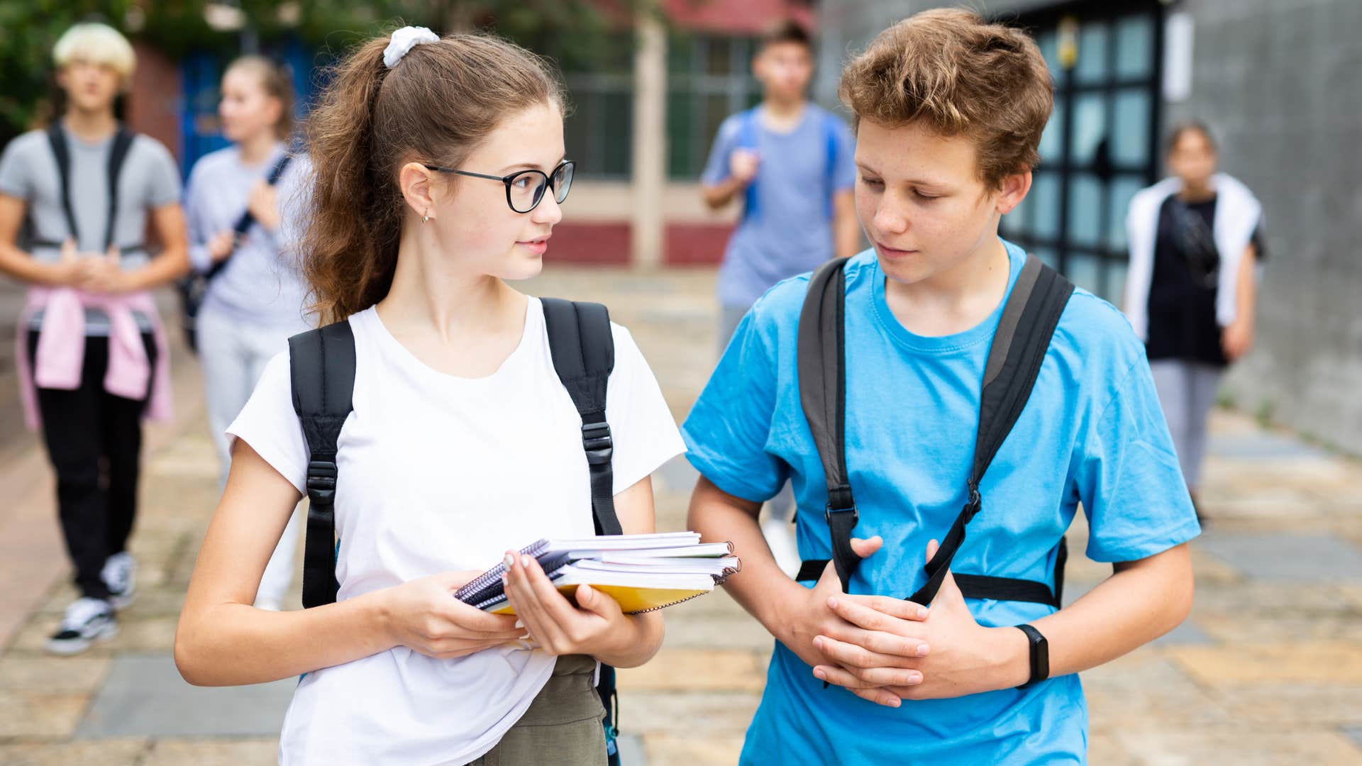 teenage boy and girl walking together