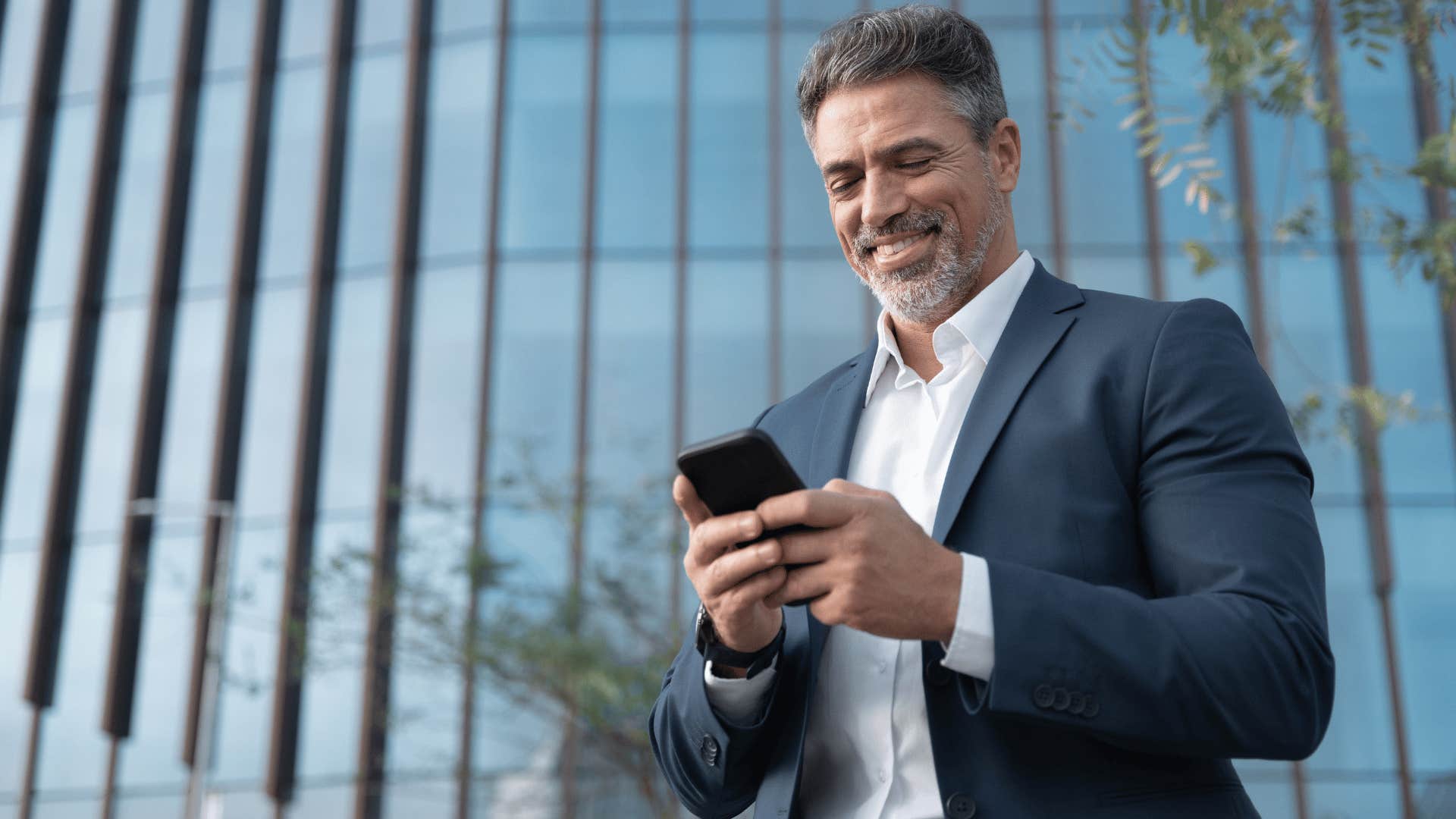 man checking in with loved ones on his phone 