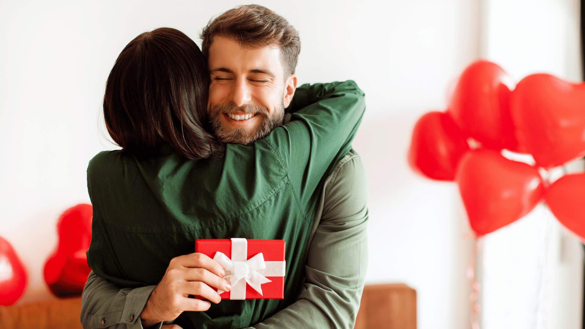 man surprising woman with a present