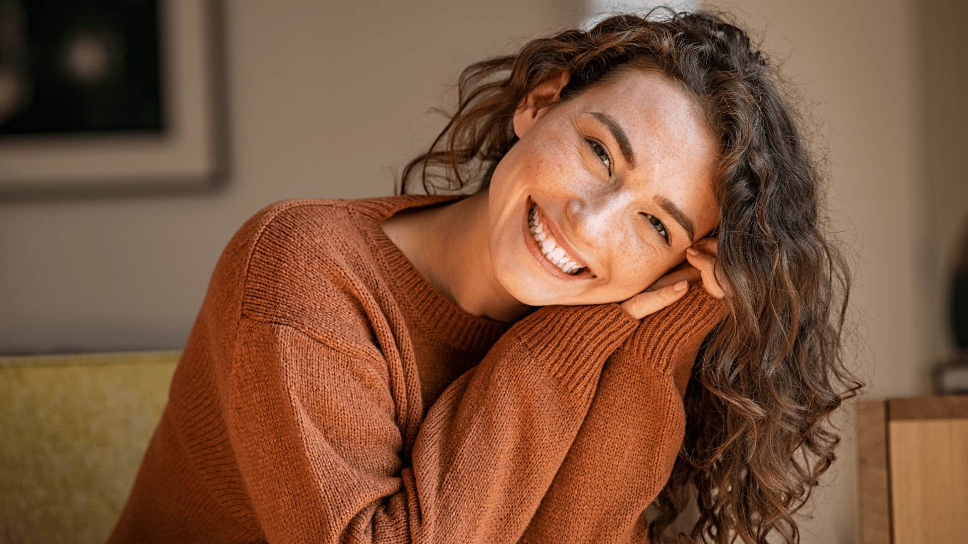 woman smiling with head tilted