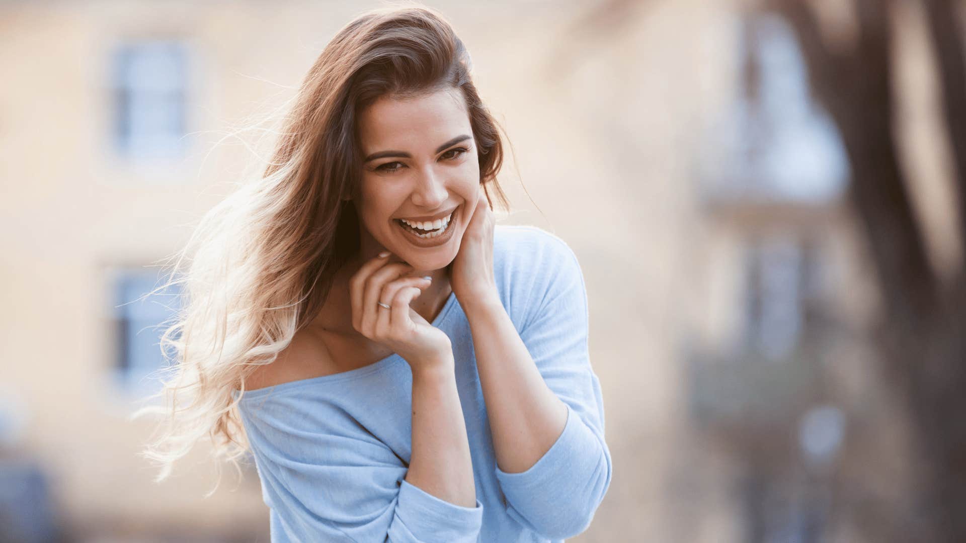 woman touching her hair 