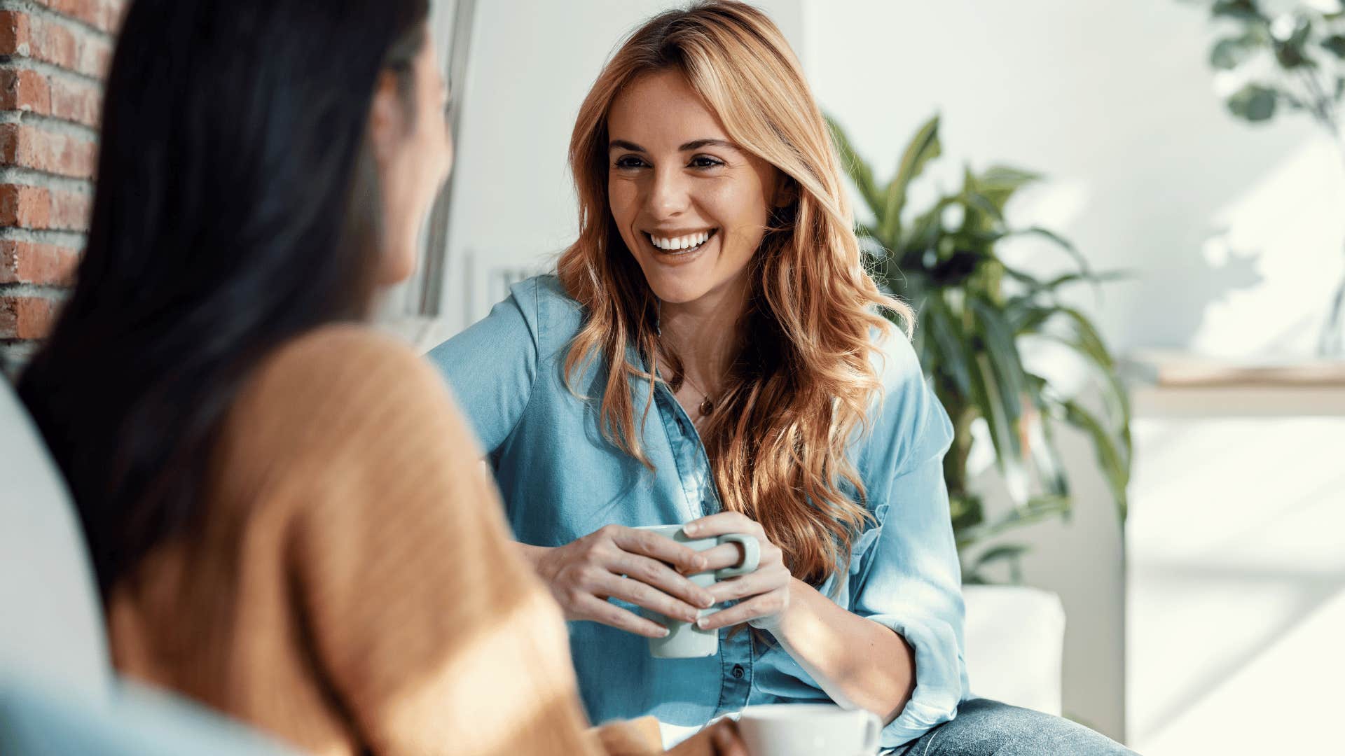 two women talking on the couch 