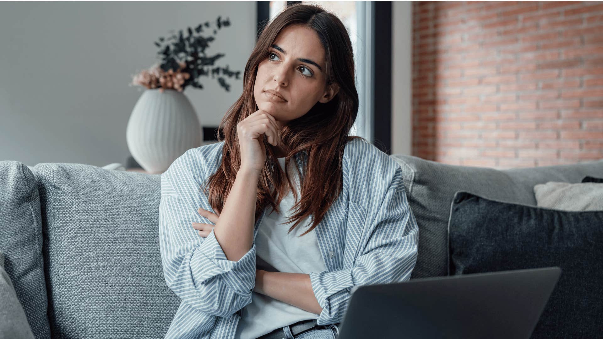 woman thinking and touching chin