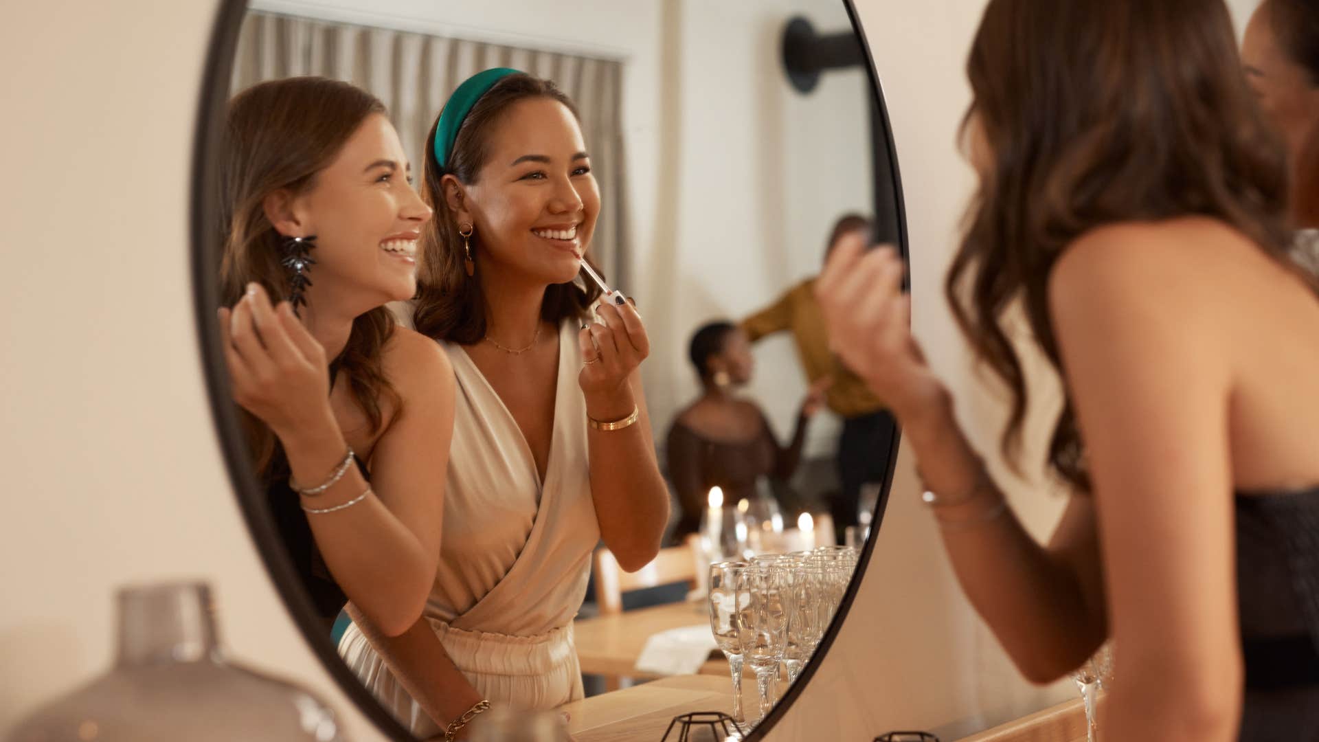 women getting ready in mirror together