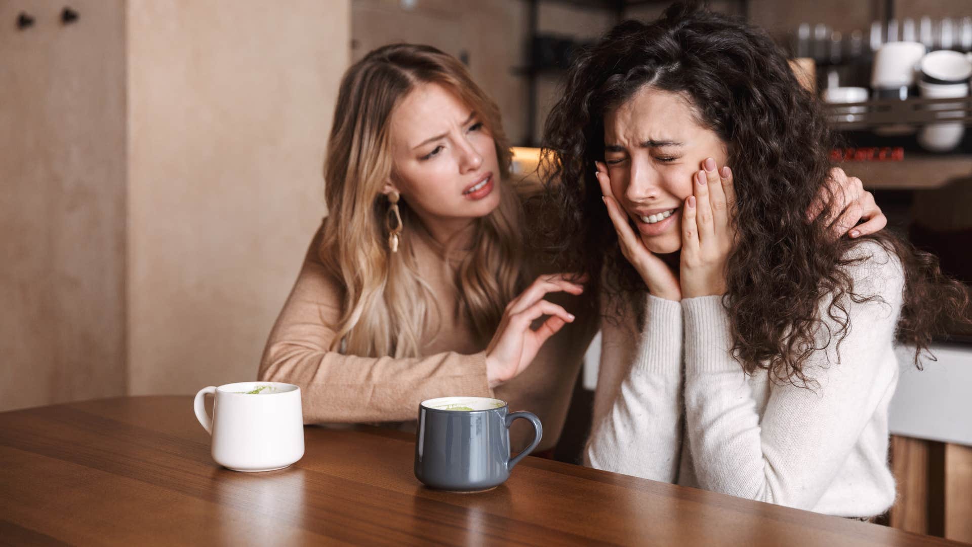 woman listening to another woman while she cries