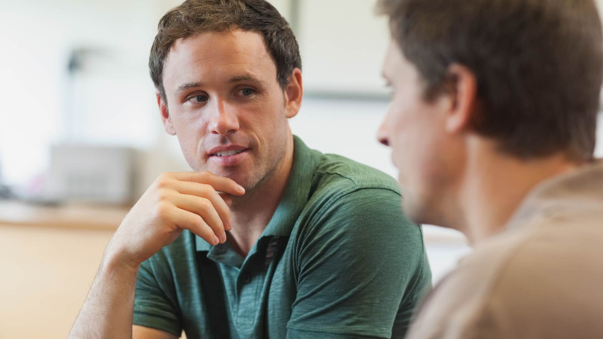 man listening to his friend talk