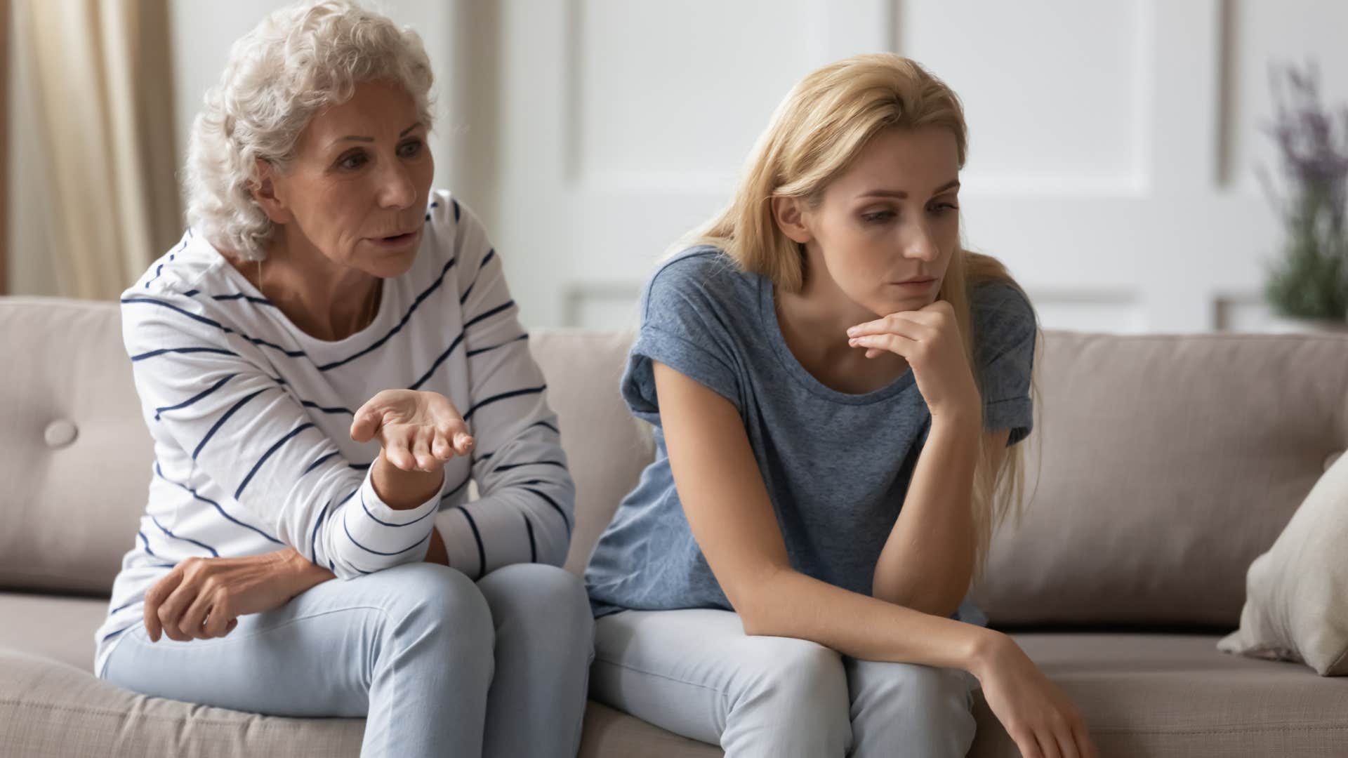 young woman avoiding eye contact with older woman