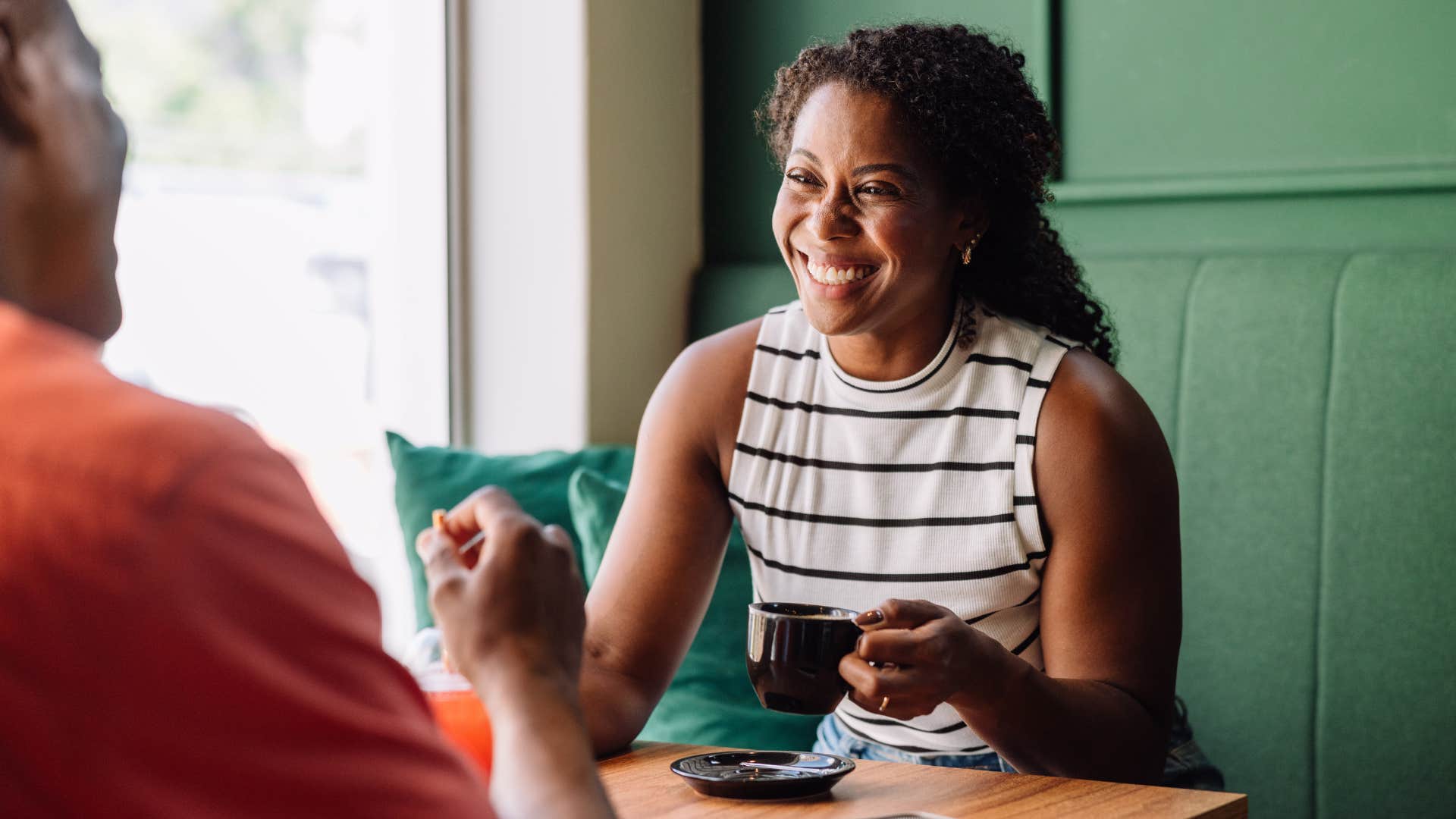 woman smiling while talking with man