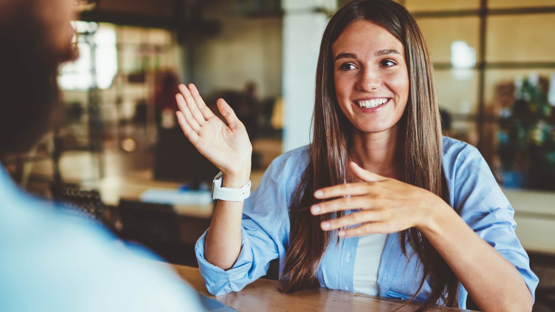 woman smiling and talking to a man