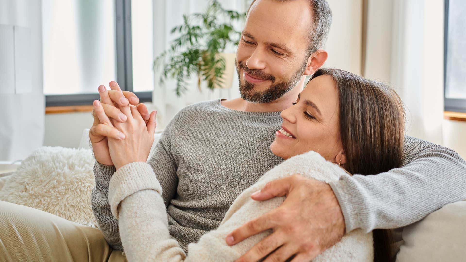 couple holding hands smiling